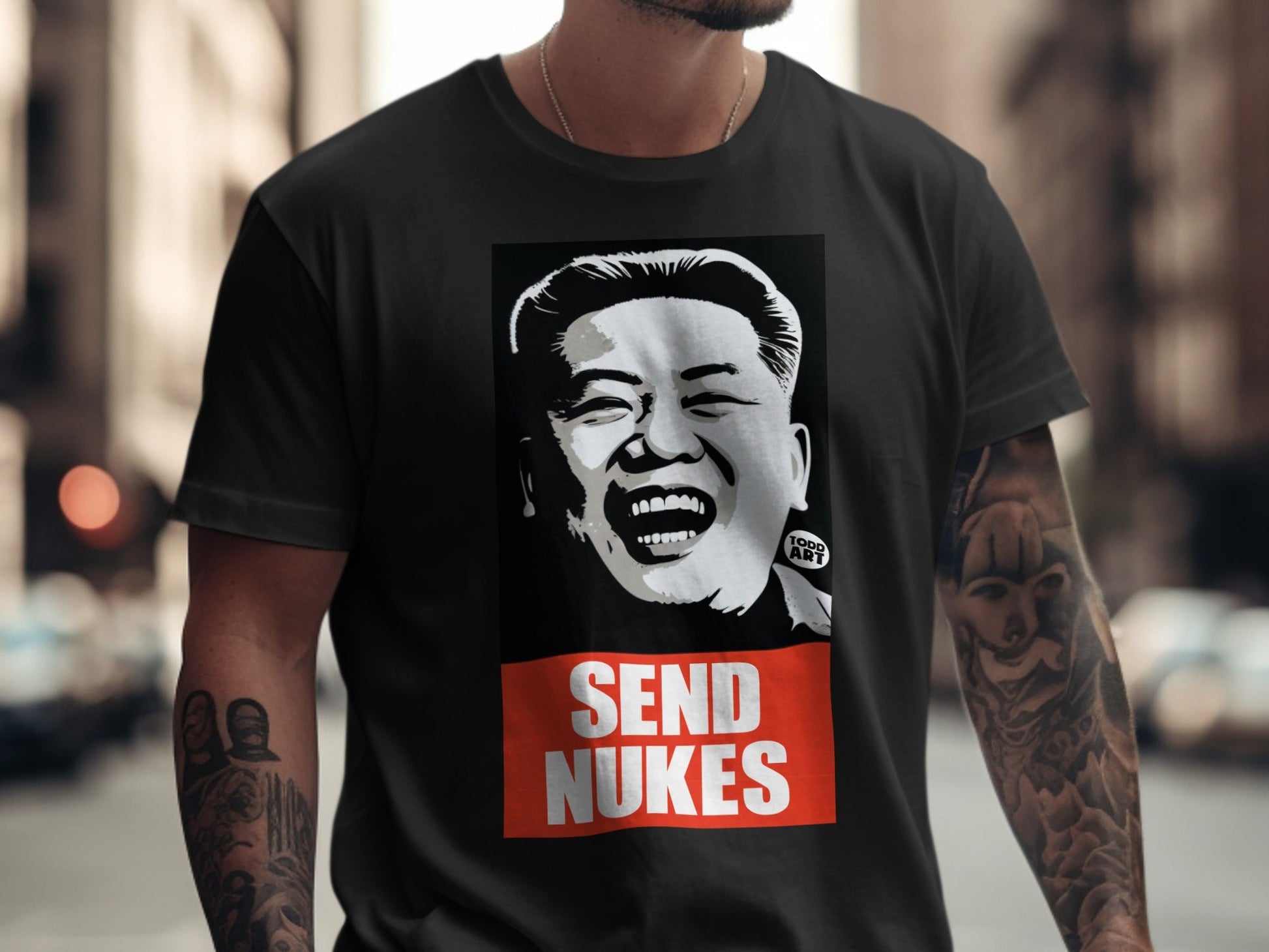 Black t-shirt with a black and white portrait of Kim Jong Un and "SEND NUKES" text.
