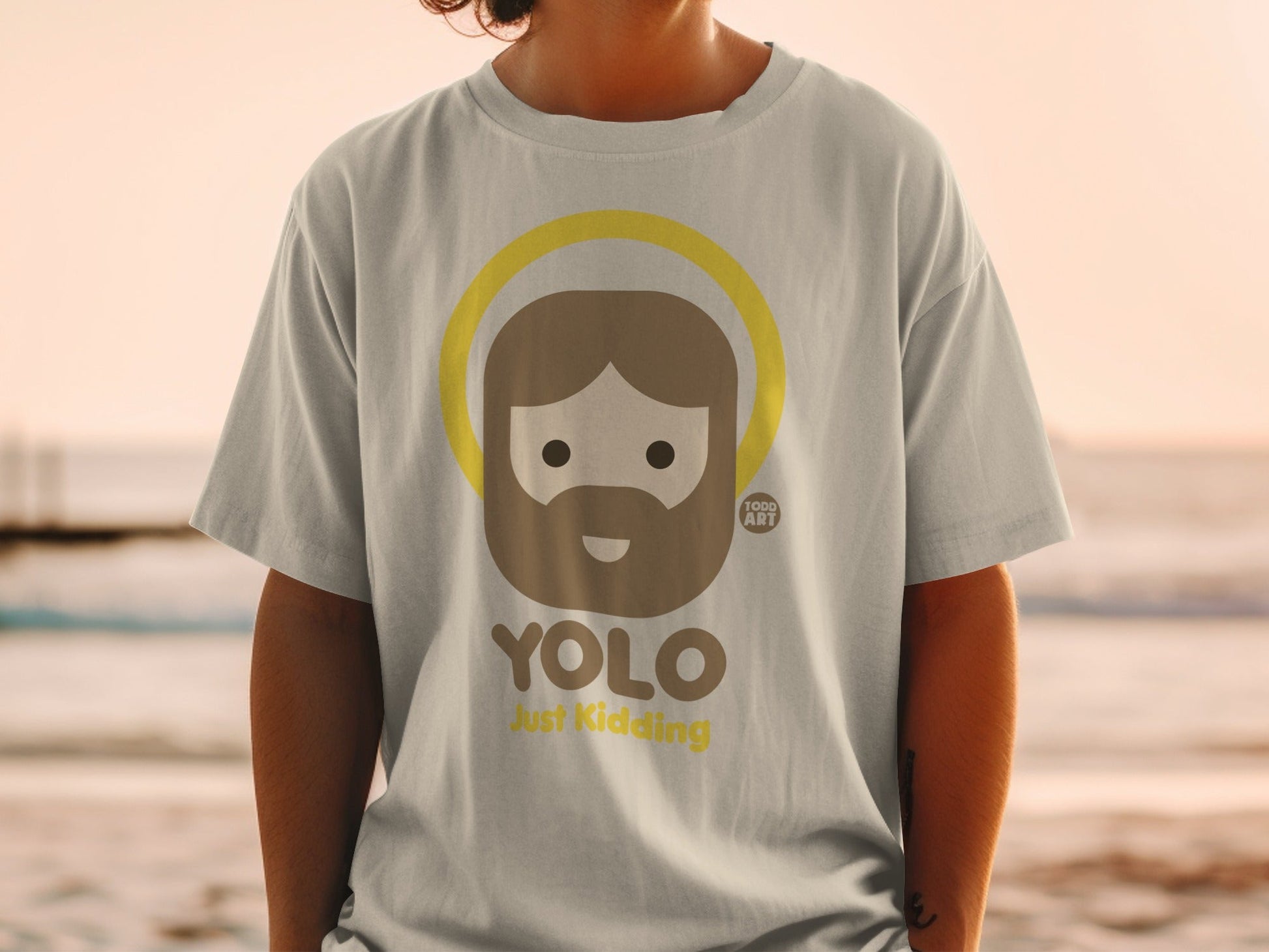 T-shirt with cartoon Jesus, halo, and "YOLO Just Kidding" text.