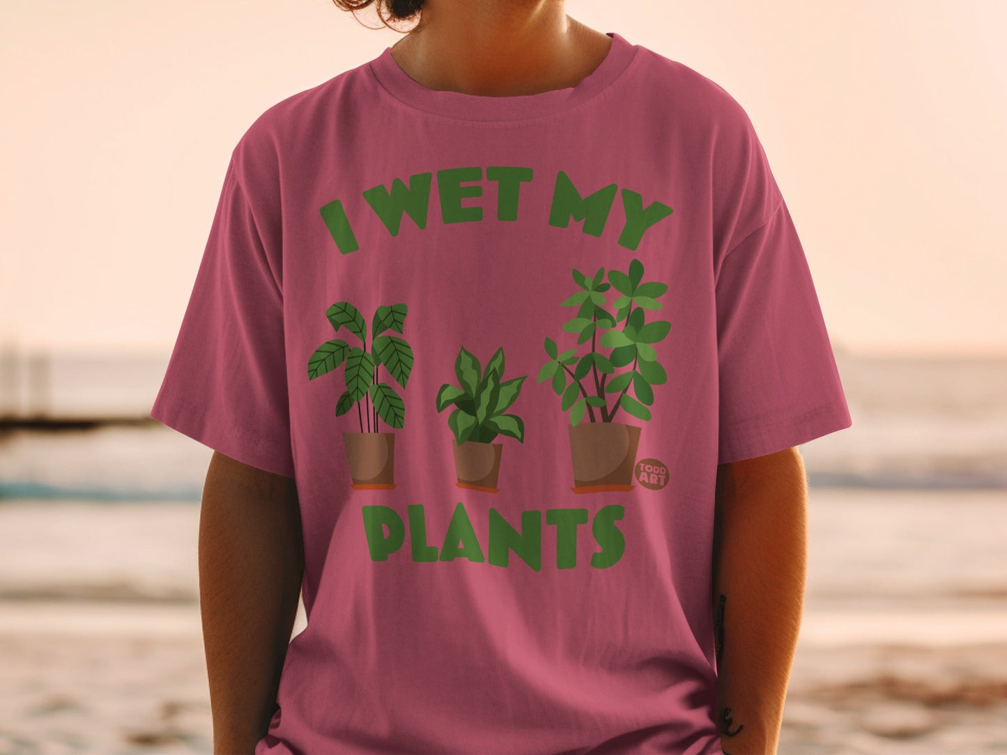T-shirt with "I WET MY PLANTS" in green text and cartoon plants.