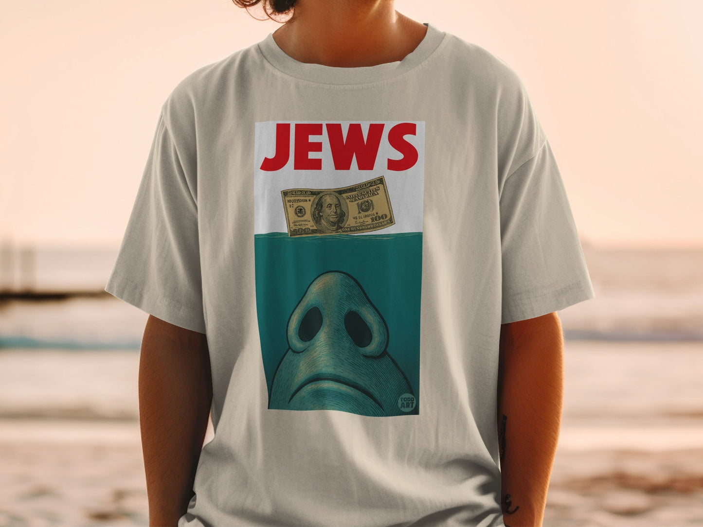 T-shirt with "JEWS" text above a shark's snout and a $100 bill.