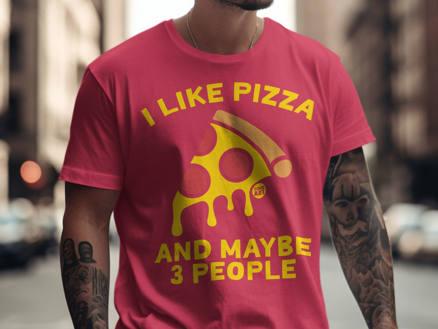 Pink t-shirt with yellow "I LIKE PIZZA AND MAYBE 3 PEOPLE" text and pizza slice.