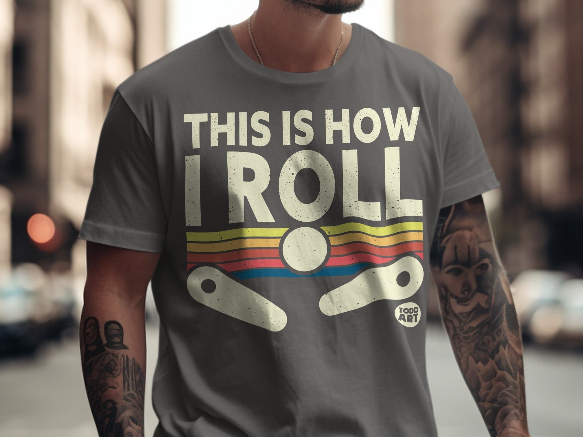 Grey t-shirt with "THIS IS HOW I ROLL" and a pinball graphic.