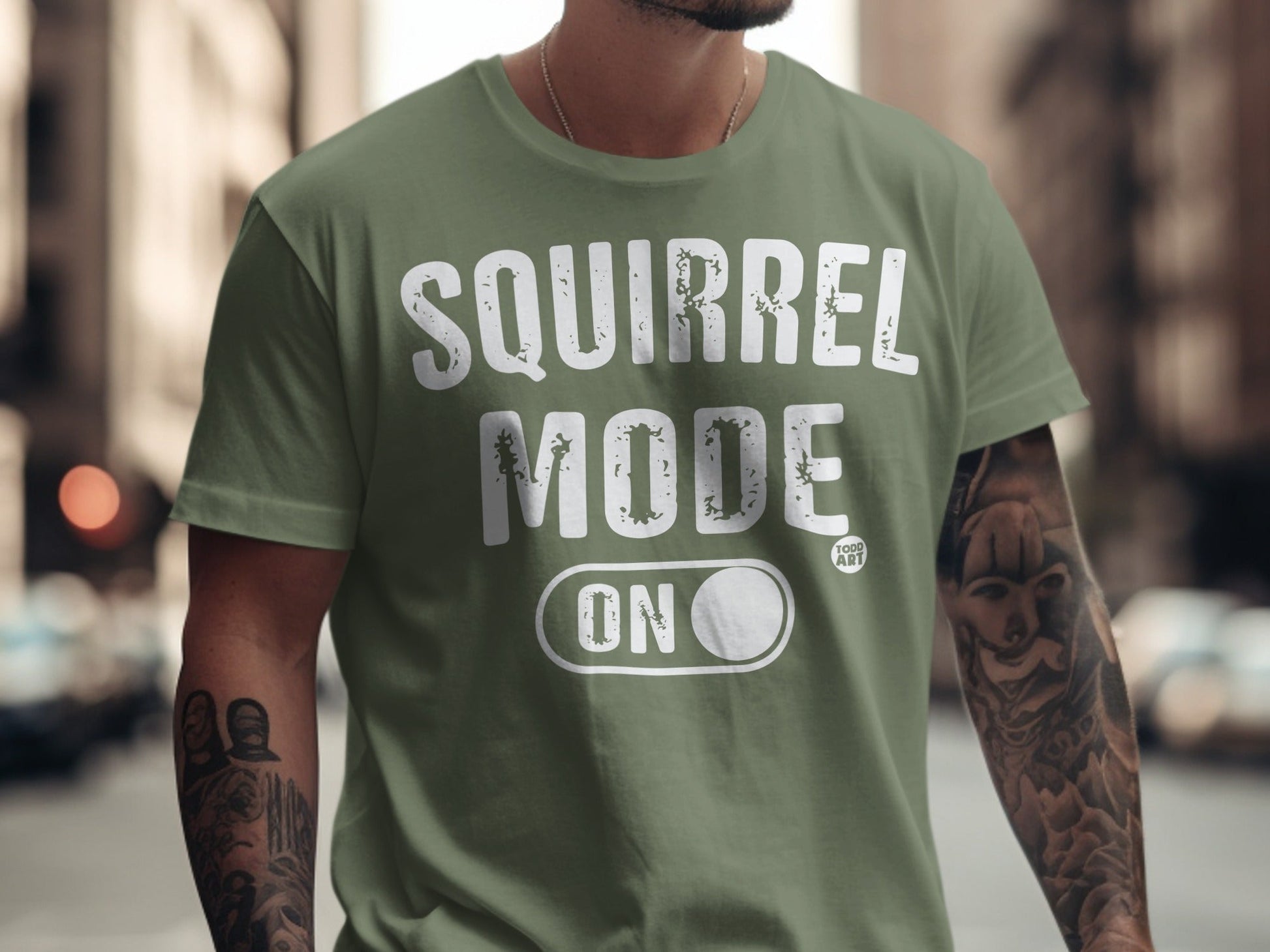 Green t-shirt with "SQUIRREL MODE ON" text.