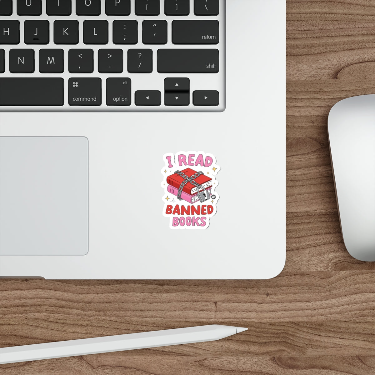 "I READ BANNED BOOKS" sticker on a laptop keyboard.