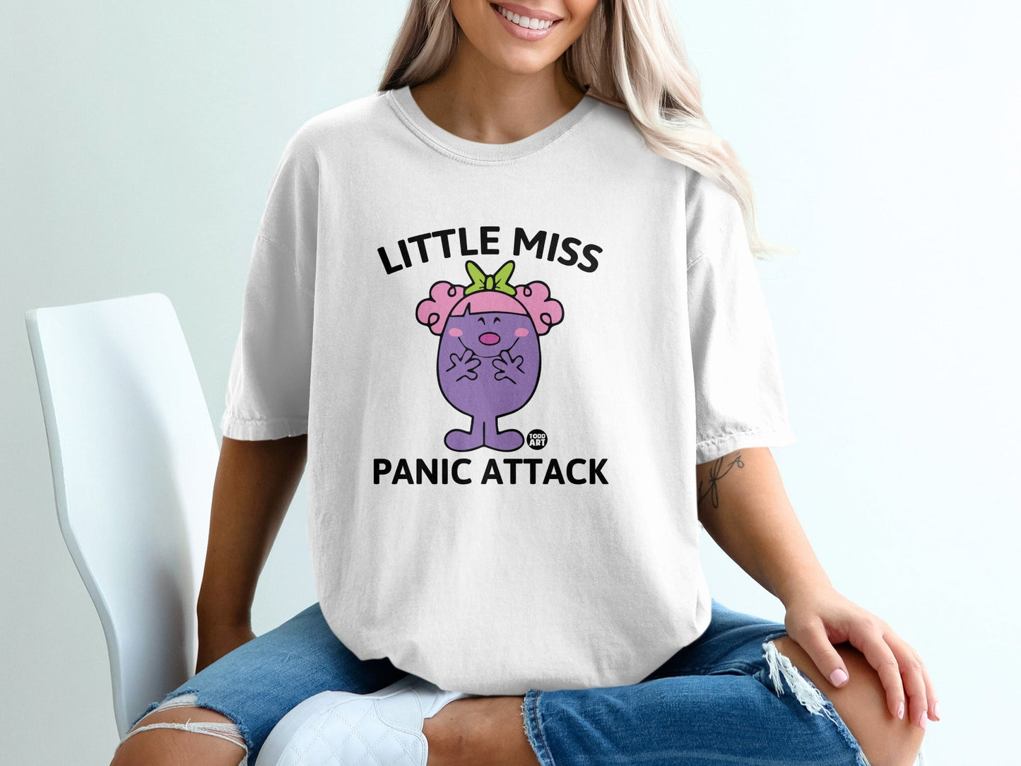 White t-shirt with "Little Miss Panic Attack" graphic and character.