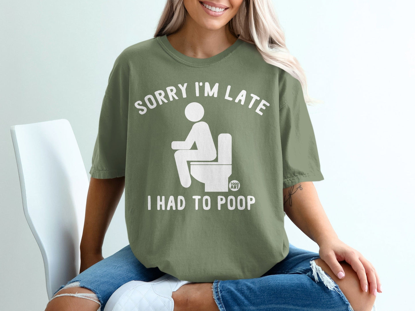 Olive green t-shirt with white text: "SORRY I'M LATE I HAD TO POOP".