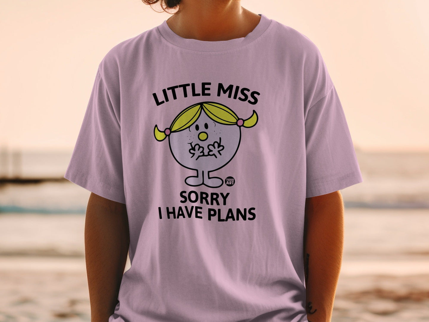 Lilac t-shirt with "Little Miss Sorry I Have Plans" text and character.