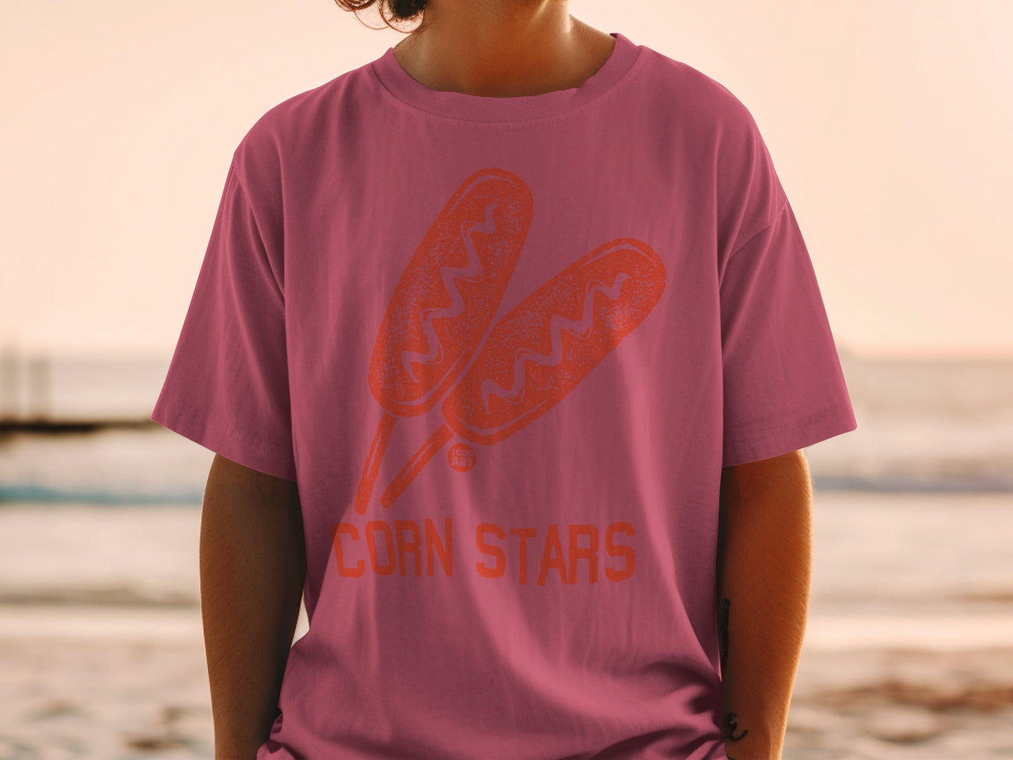 Pink t-shirt with orange corn dog graphic and "CORN STARS" text.