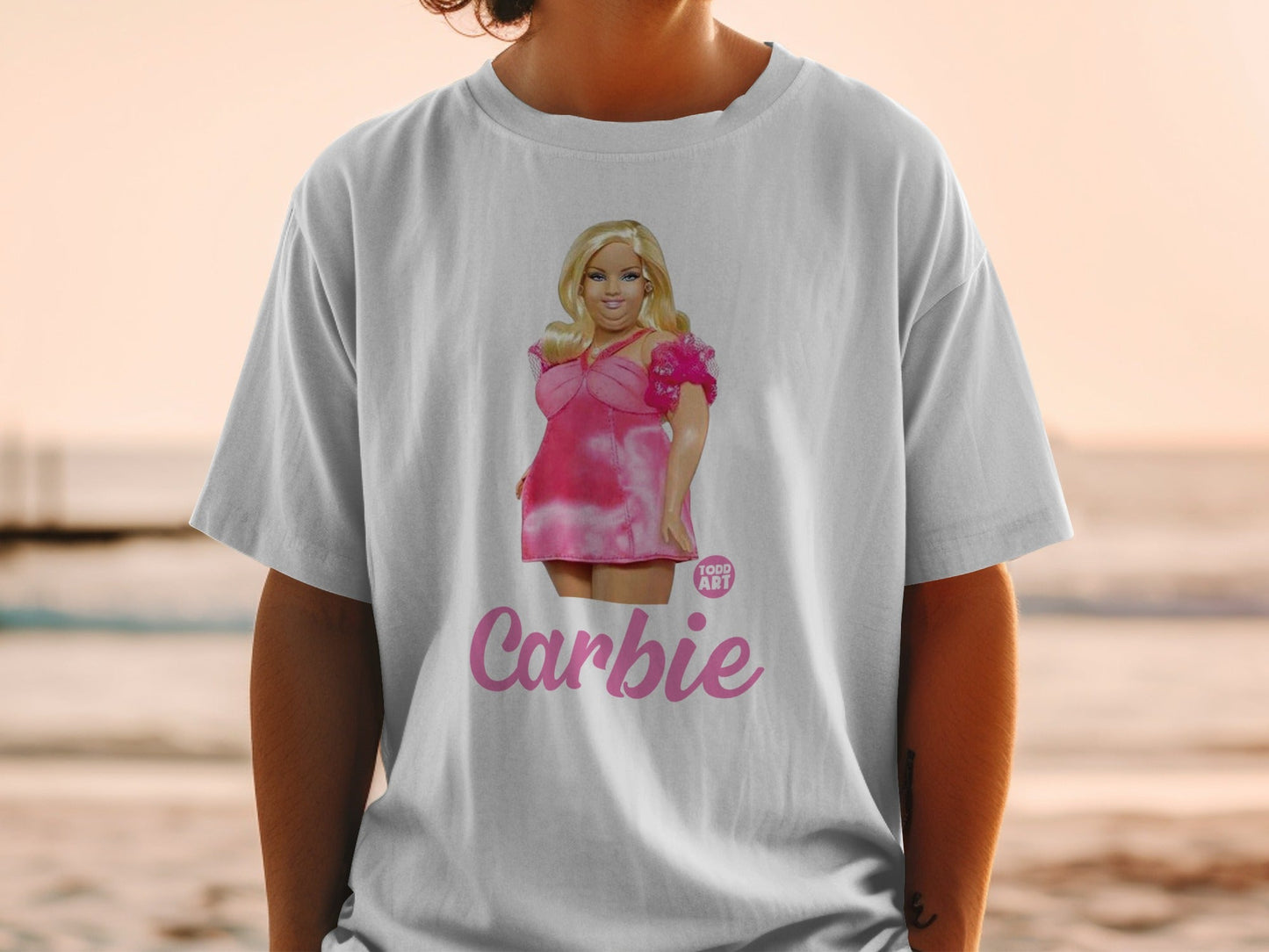White t-shirt with a Barbie doll graphic and "Carbie" text.