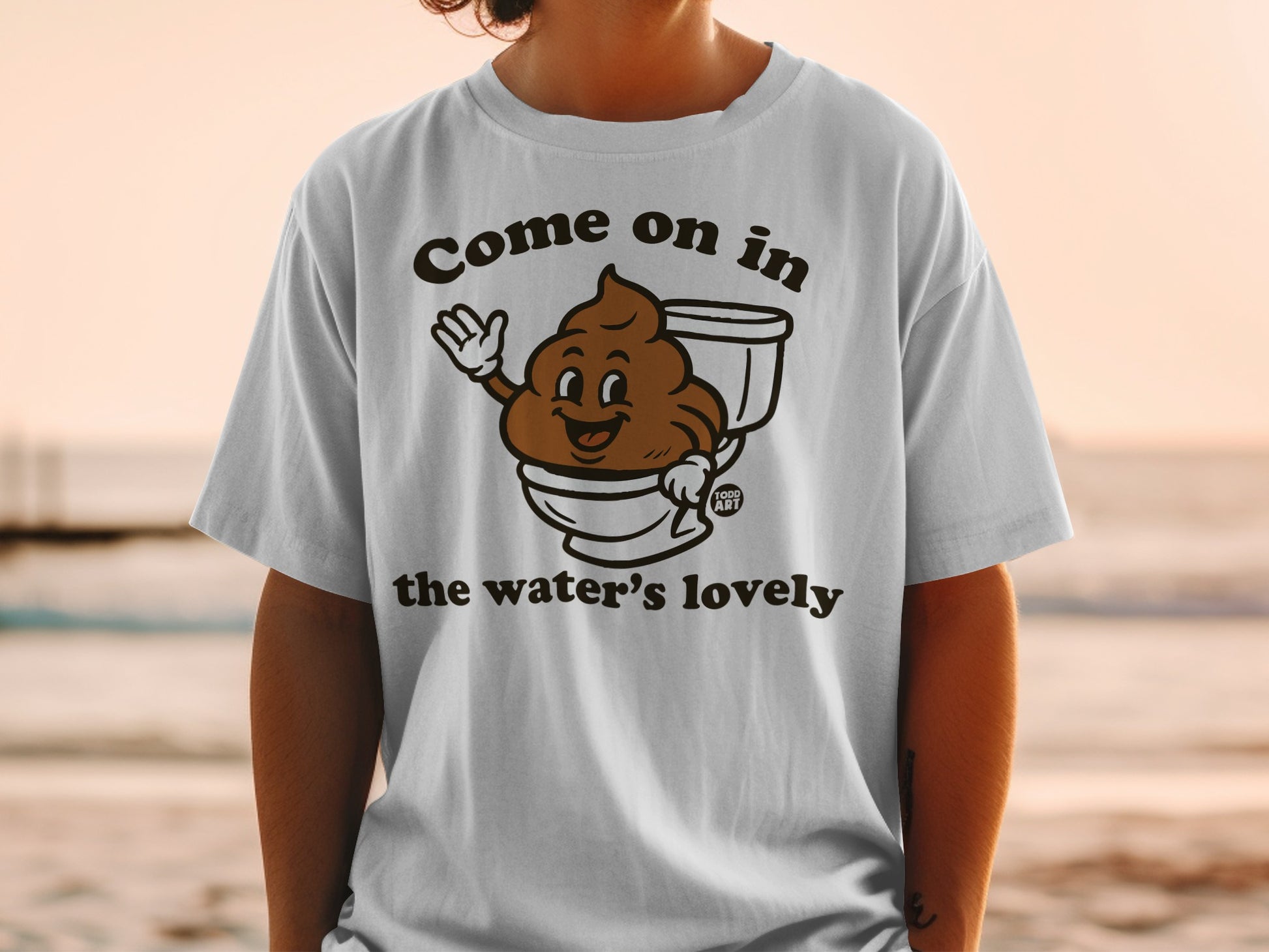 T-shirt with cartoon smiling poop in toilet, text "Come on in the water's lovely".