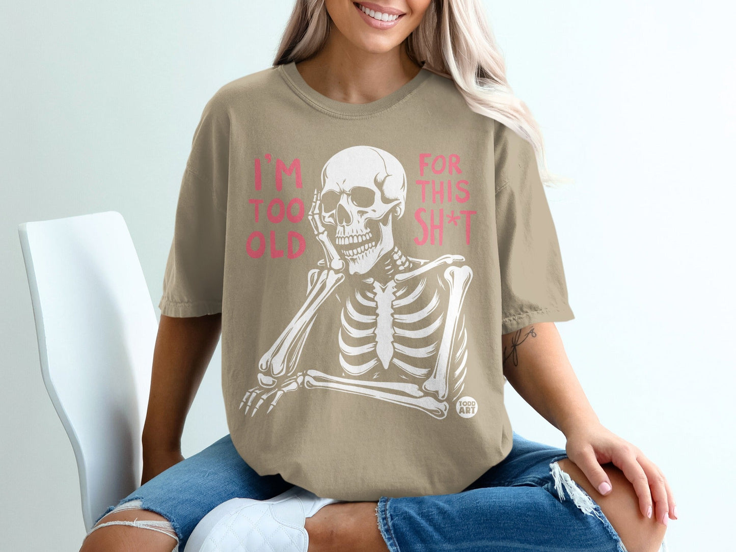 Skeleton wearing tan t-shirt with pink text "I'M TOO OLD FOR THIS SH*T".