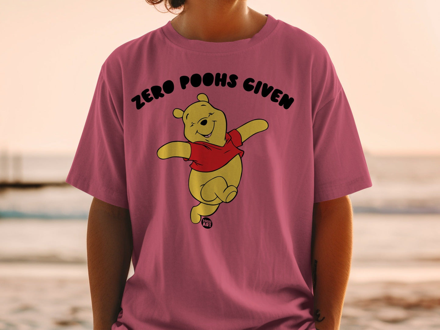 Winnie the Pooh on a pink t-shirt with "Zero Poohs Given" text.