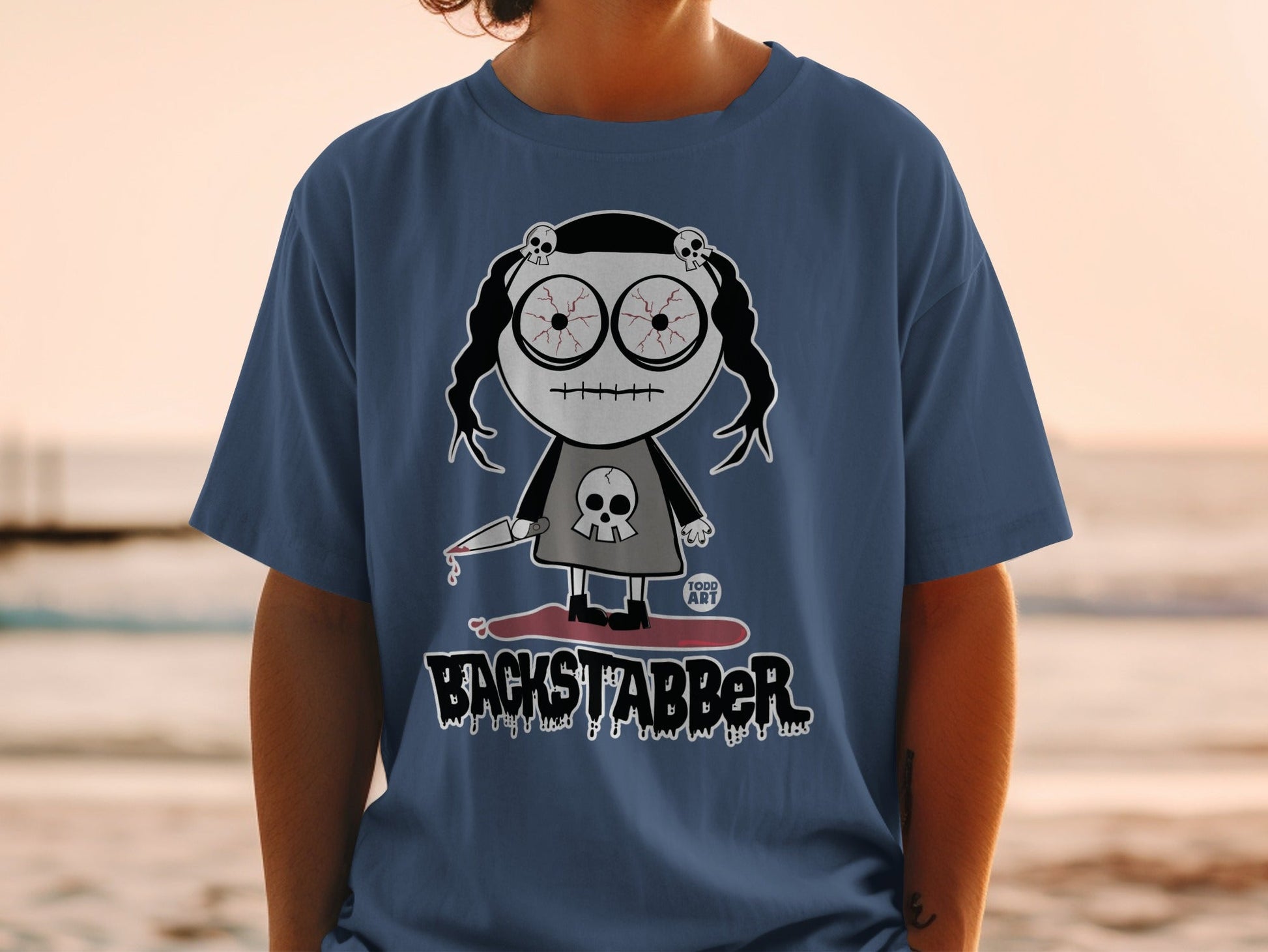 Backstabber Character Shirt with Creepy Doll Design
