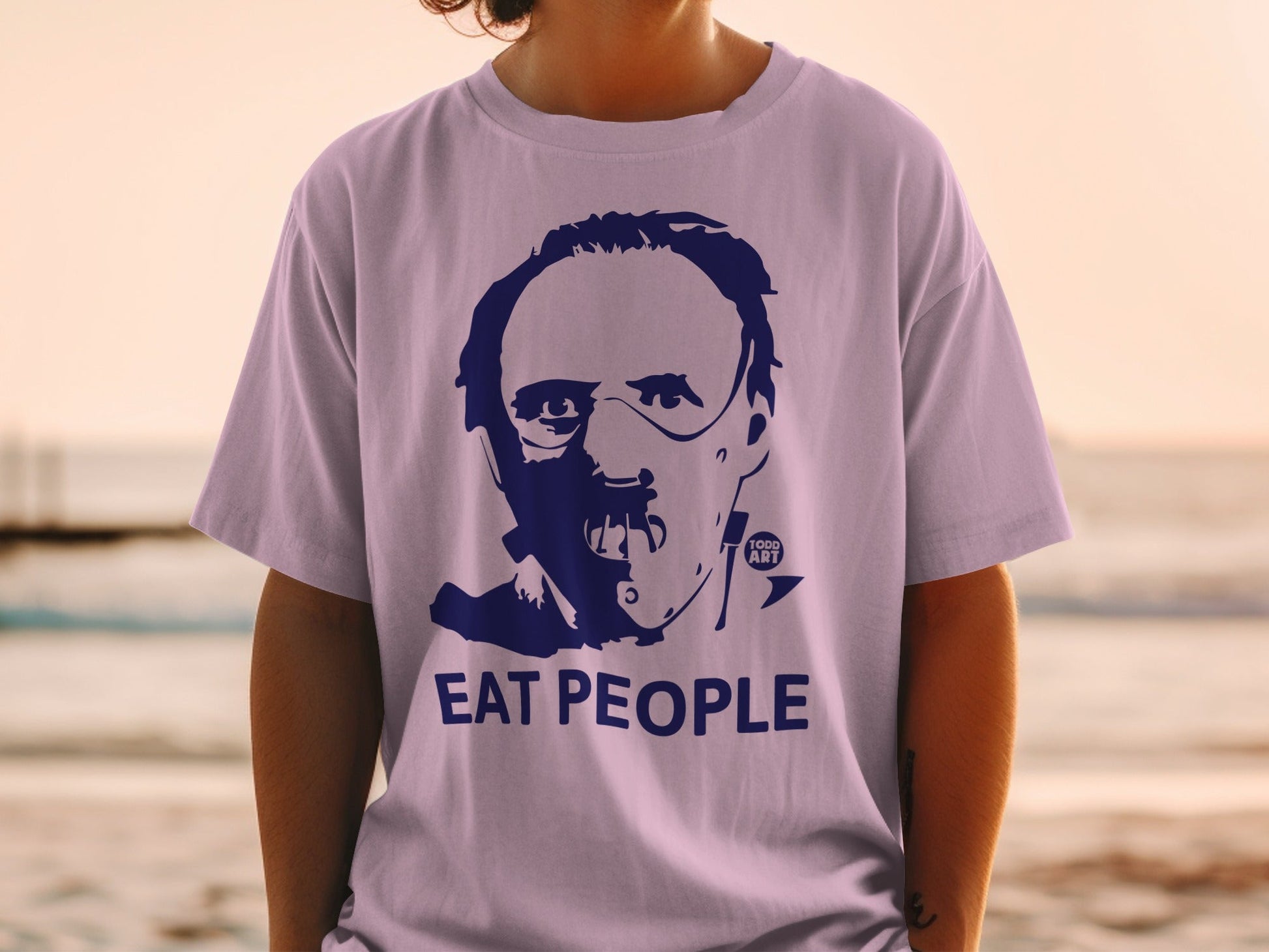 Purple t-shirt with a graphic of a man's face and "EAT PEOPLE" text.