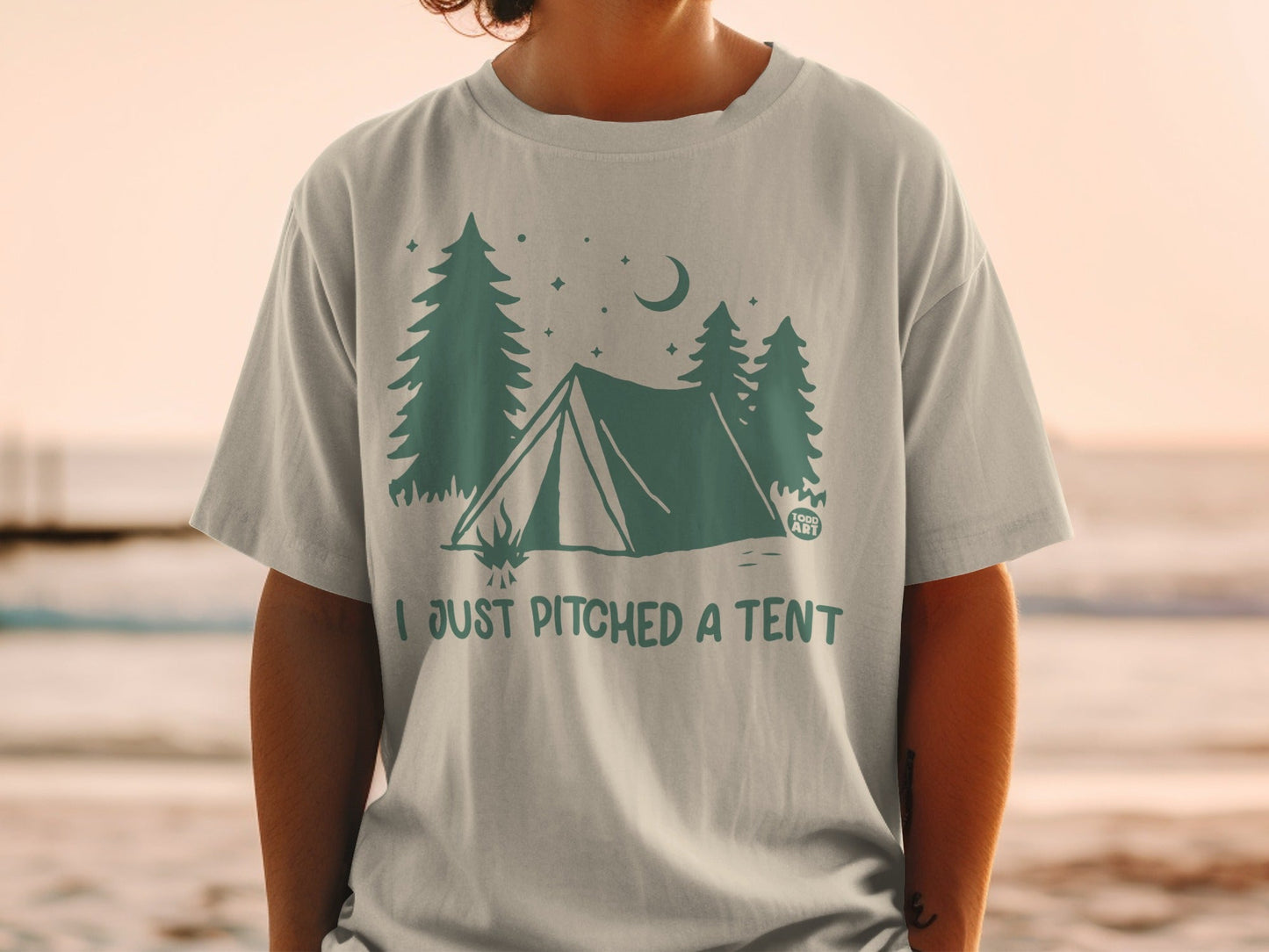 T-shirt with tent, trees, and moon graphic; text reads "I JUST PITCHED A TENT".
