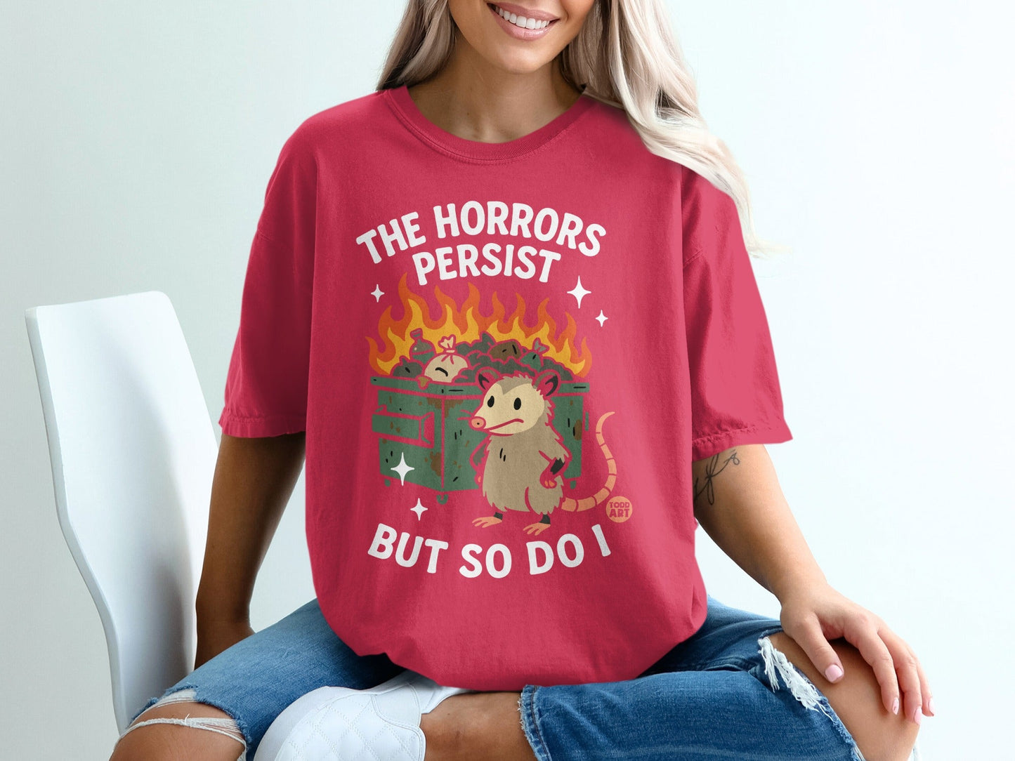 Opossum sitting in a burning dumpster with text "The Horrors Persist But So Do I".