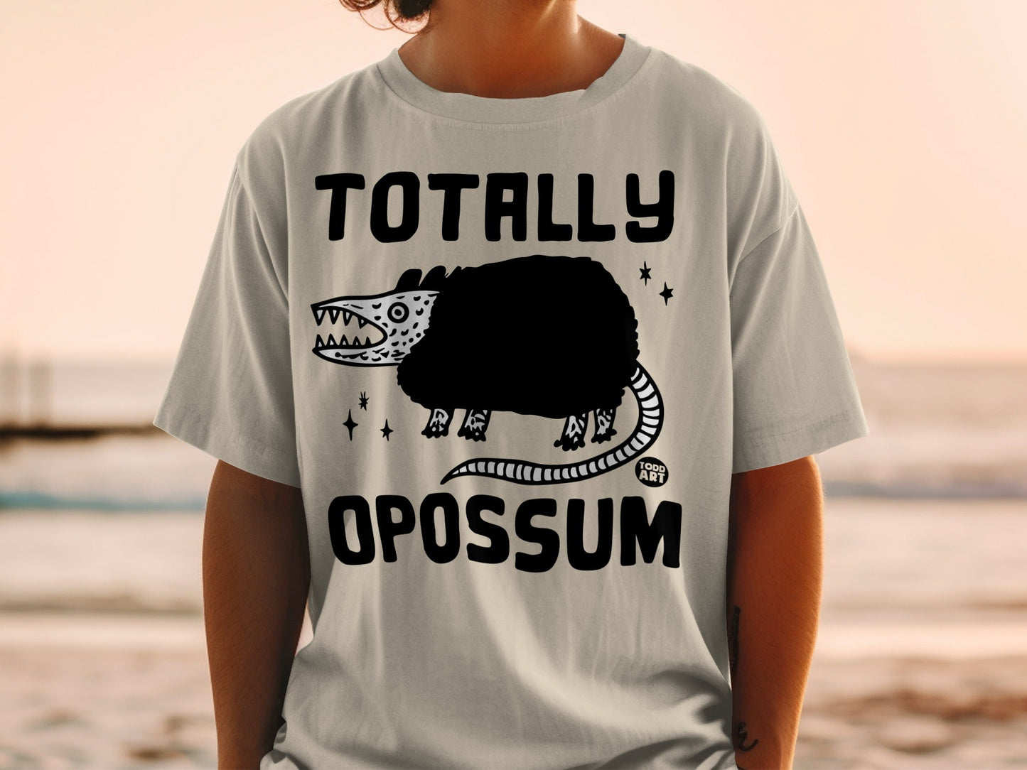 T-shirt with "TOTALLY OPOSSUM" text and cartoon opossum graphic.