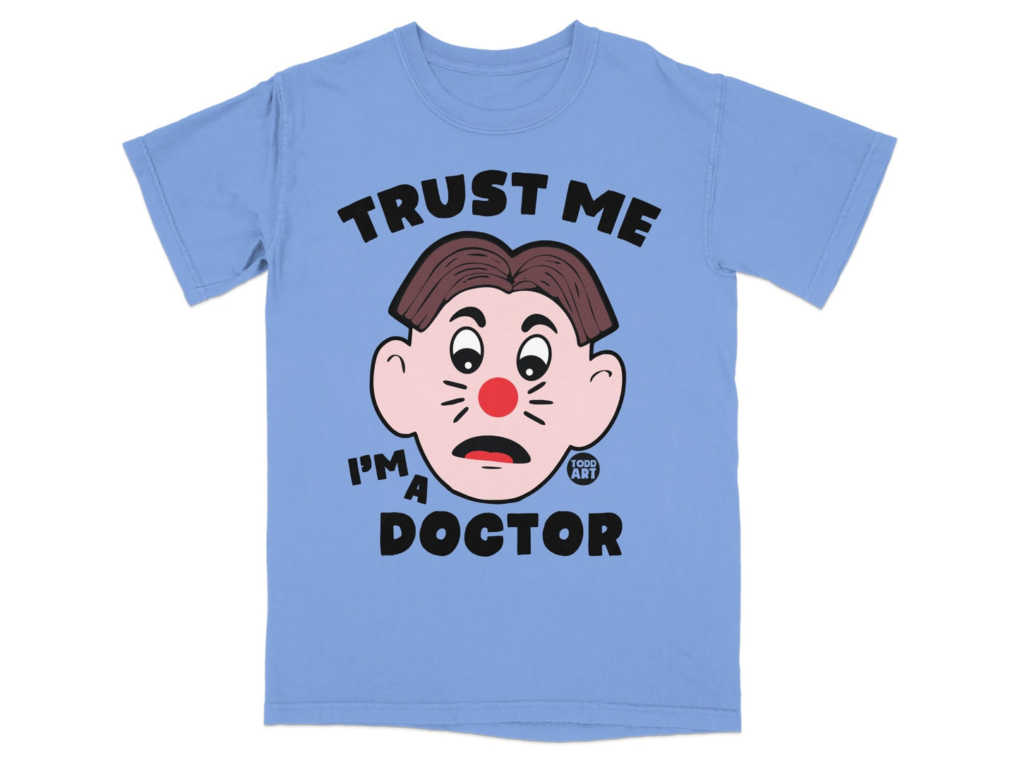 Light blue t-shirt with cartoon doctor face and text "TRUST ME I'M A DOCTOR".