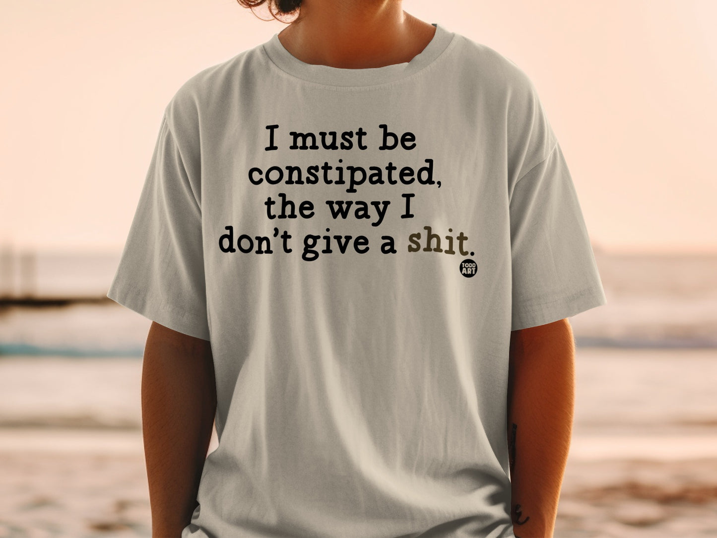 T-shirt with "I must be constipated, the way I don't give a shit." text.