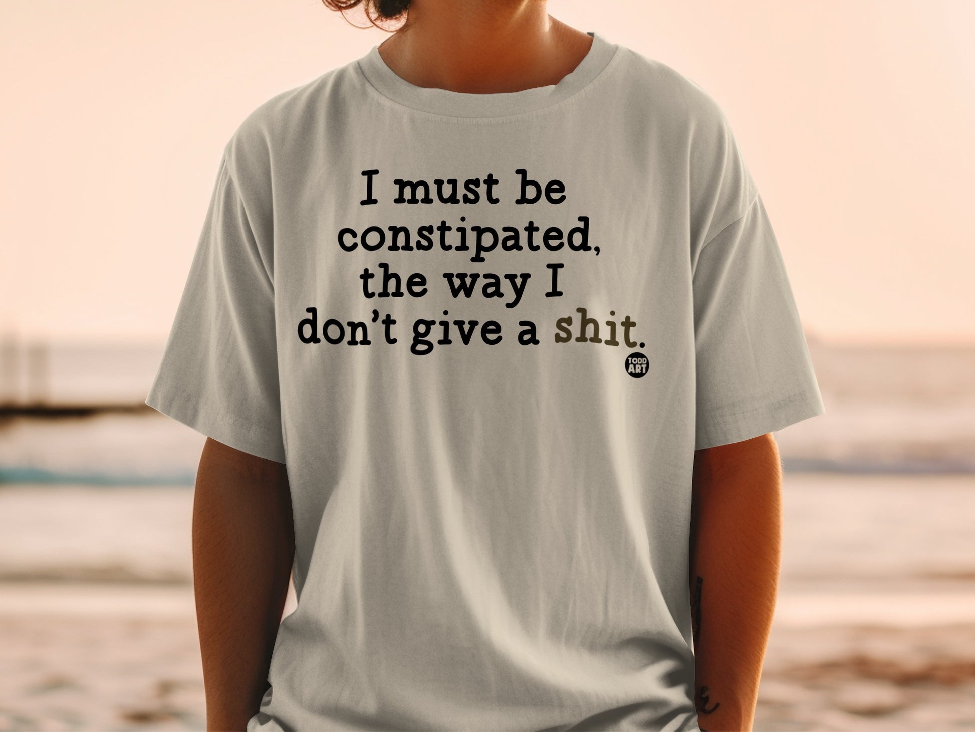 T-shirt with "I must be constipated, the way I don't give a shit." text.