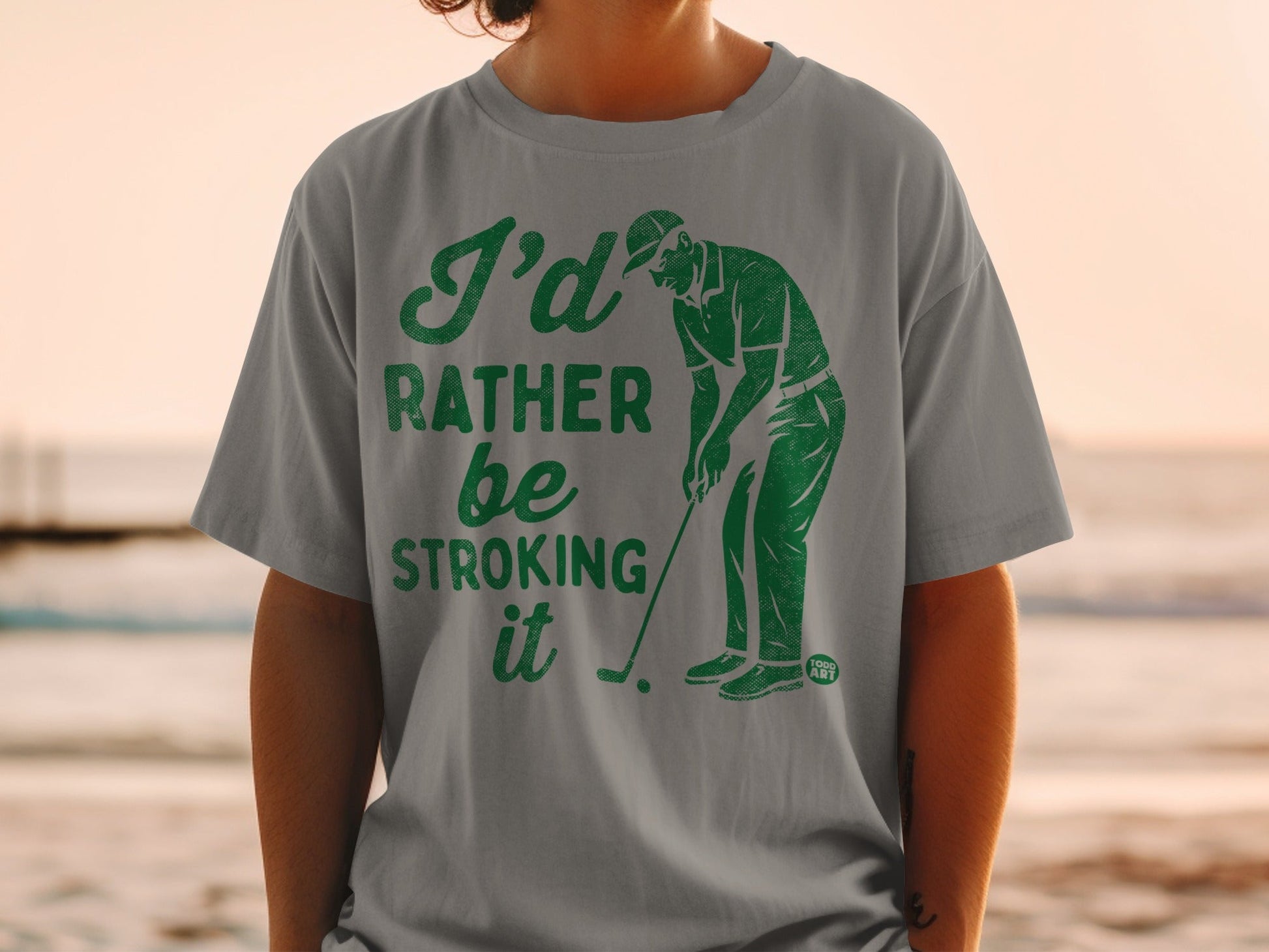 Grey t-shirt with "I'd rather be stroking it" and golfer graphic.