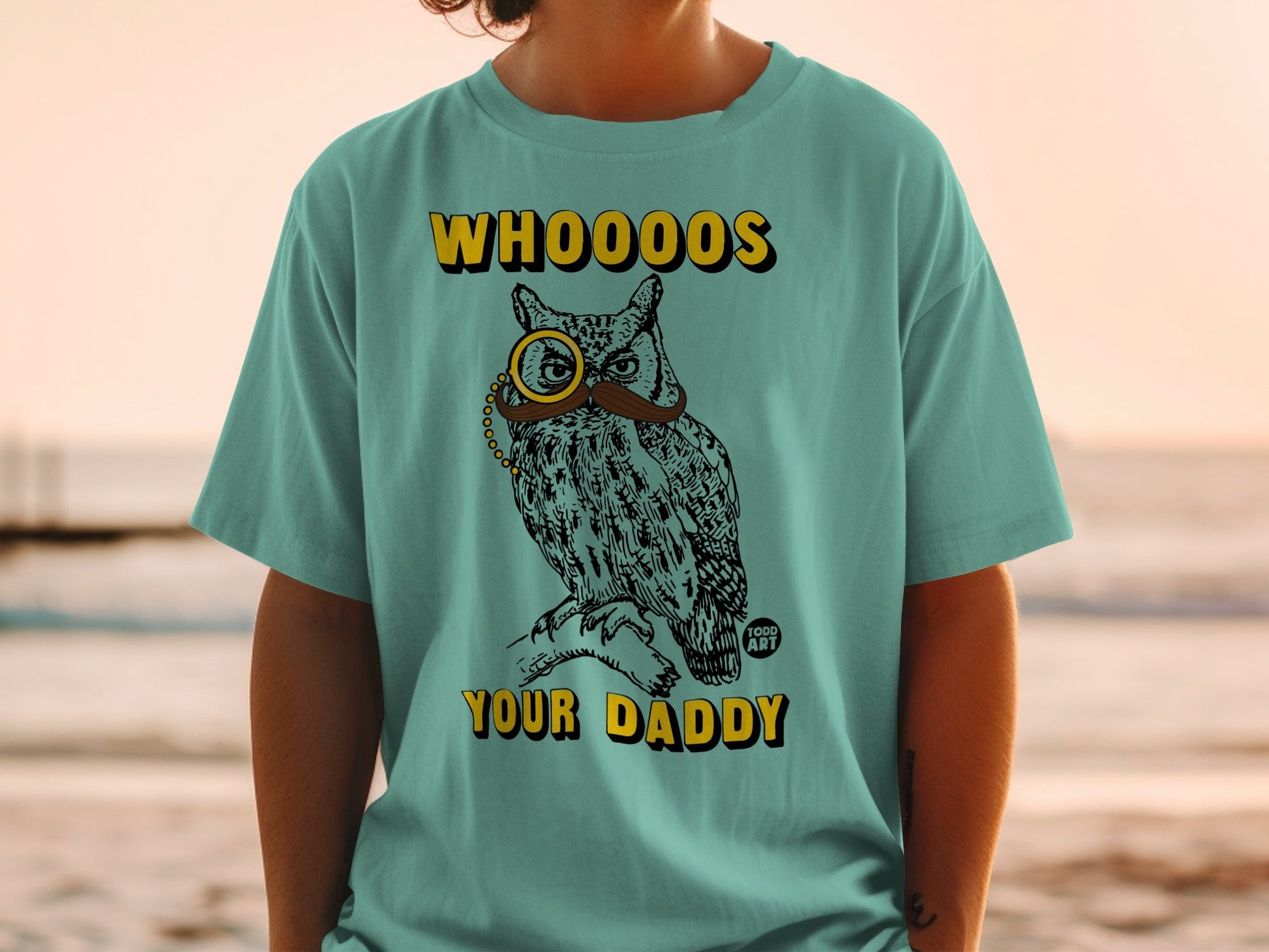 Teal t-shirt featuring an owl wearing a monocle and mustache with text "WHOOOOS YOUR DADDY".