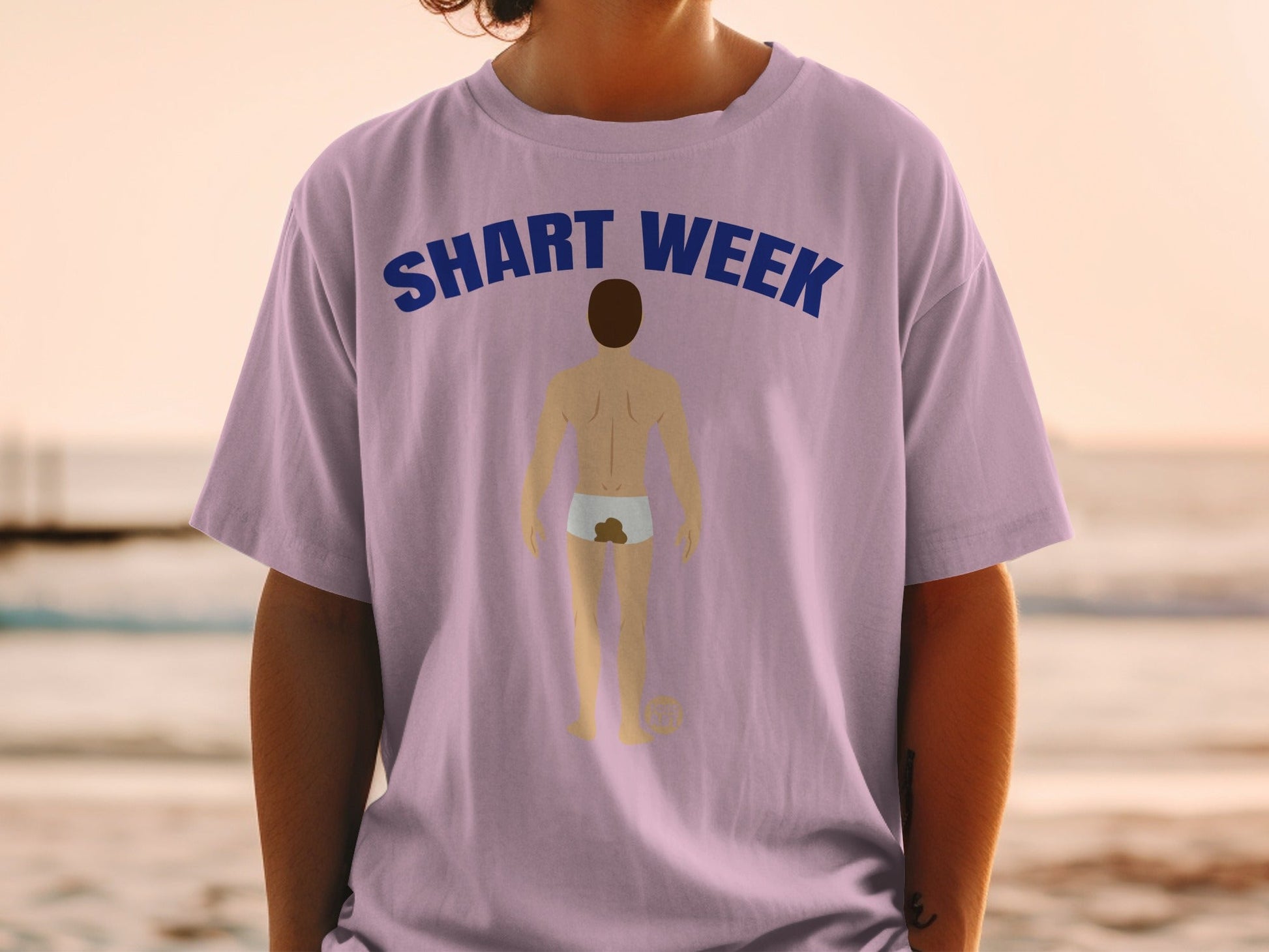 Light purple t-shirt with "SHART WEEK" text and cartoon illustration of man in underwear.