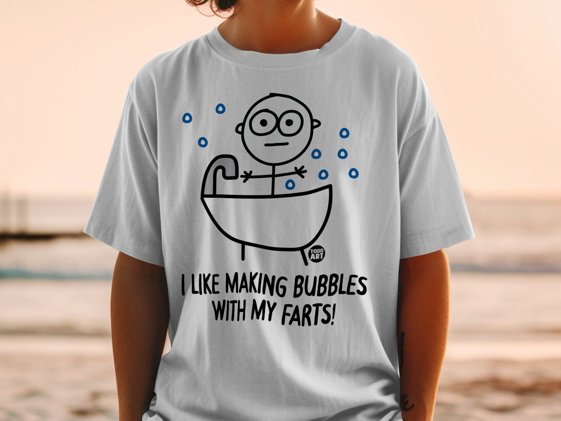 White t-shirt with cartoon man in bathtub and text "I LIKE MAKING BUBBLES WITH MY FARTS!".