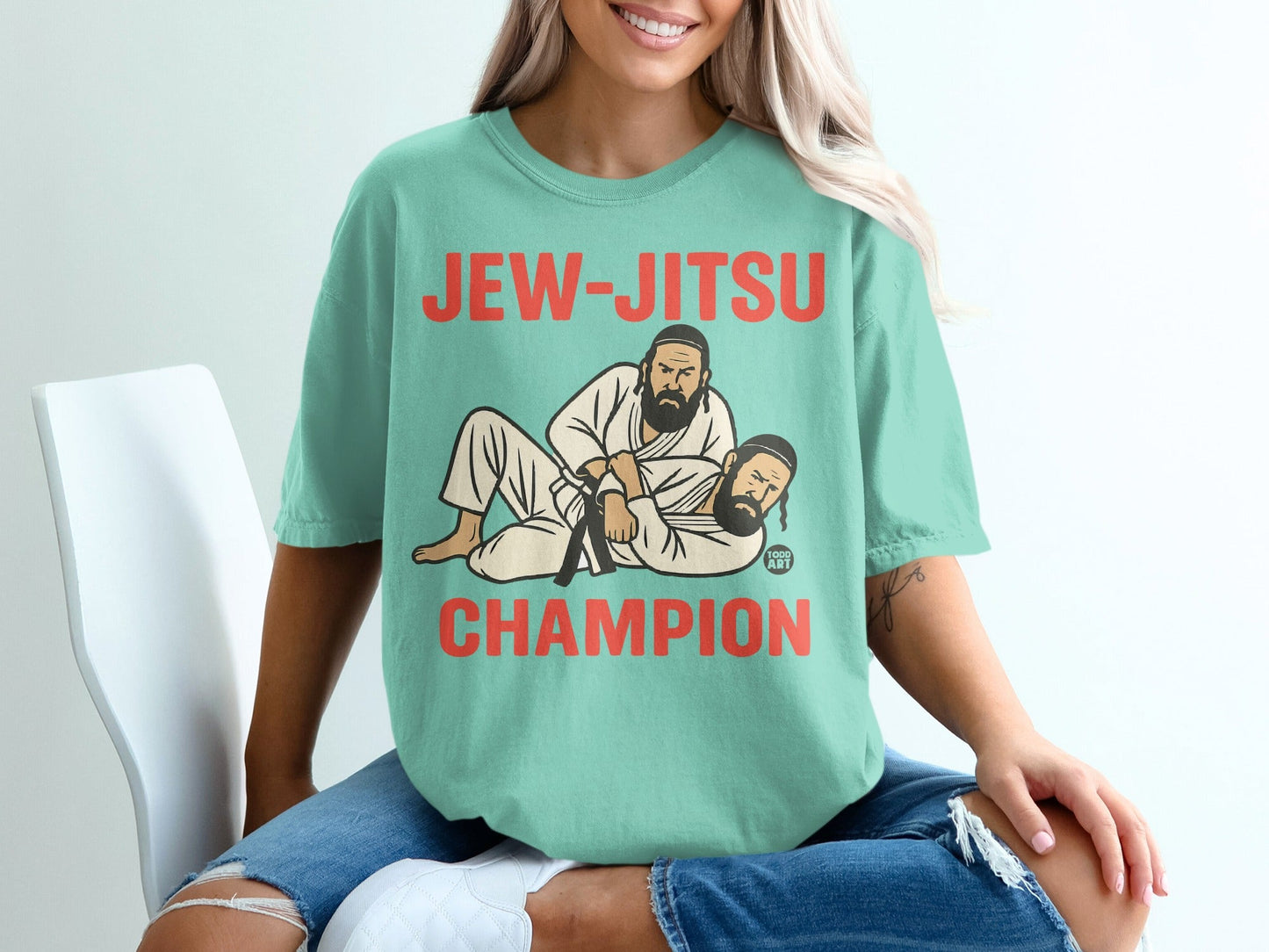 Teal t-shirt with "Jew-Jitsu Champion" text and wrestling graphic.