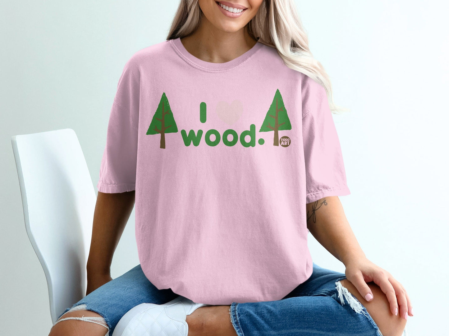 Pink t-shirt with "I love wood" text and tree graphics.