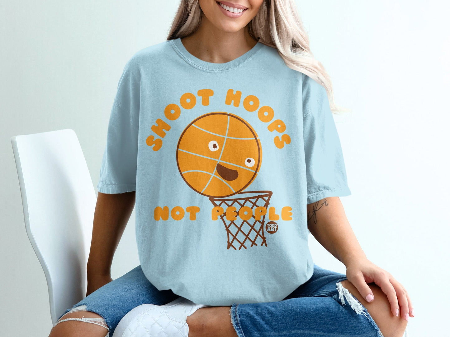 Light blue t-shirt with a cartoon basketball and hoop graphic.