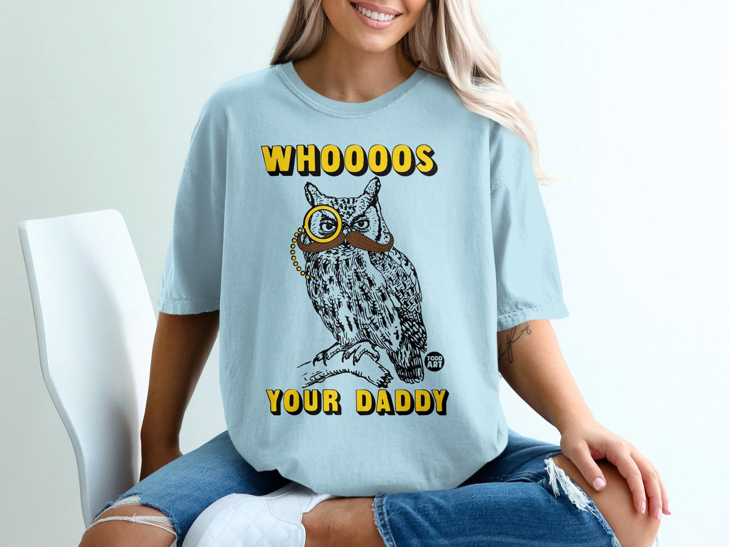 Light blue t-shirt with owl wearing monocle and "WHOOOOS YOUR DADDY" text.