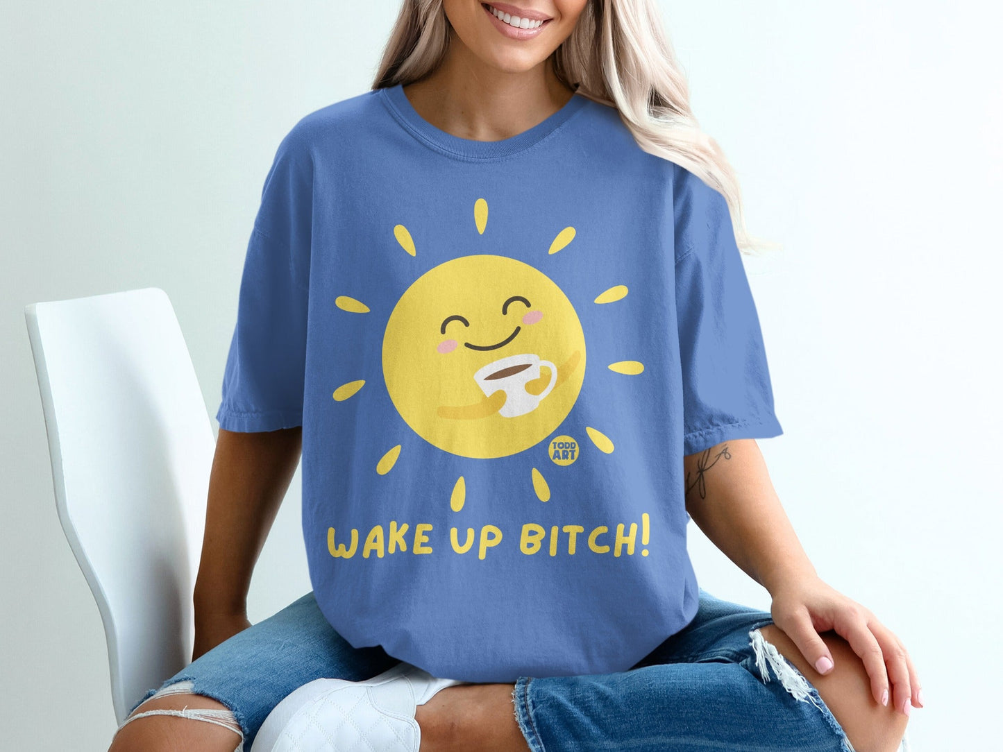 Blue t-shirt with a cartoon sun holding coffee, saying "Wake Up Bitch!"