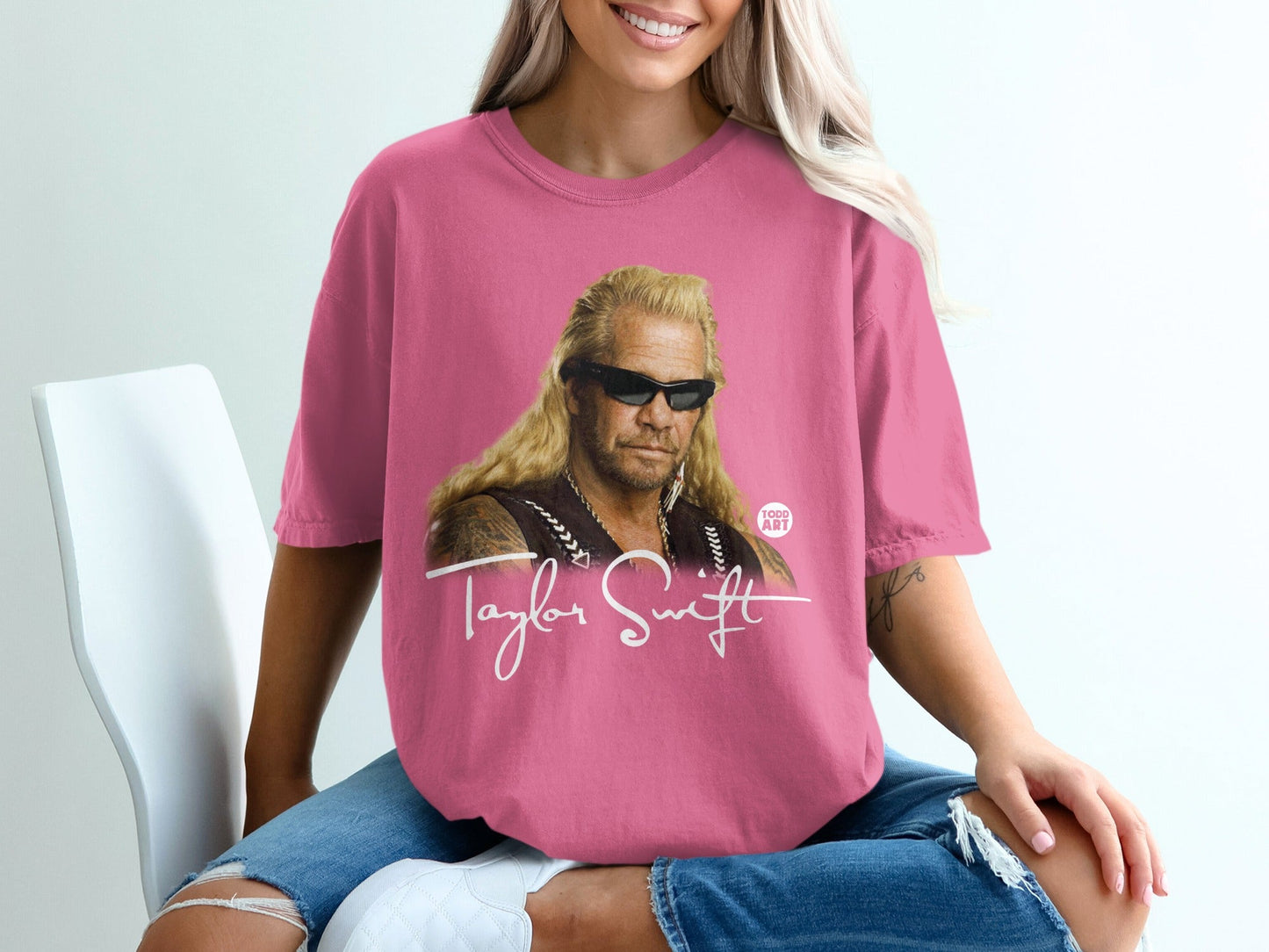 Pink t-shirt with graphic of Duane "Dog the Bounty Hunter" Chapman and "Taylor Swift" text.