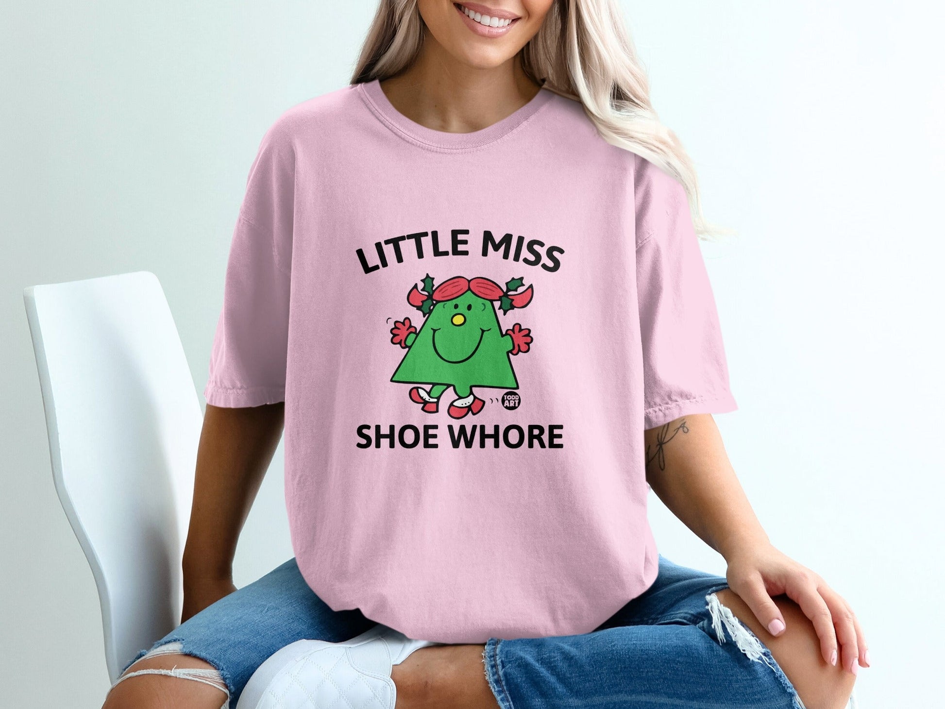 Pink t-shirt with cartoon shoe character and text "Little Miss Shoe Whore".