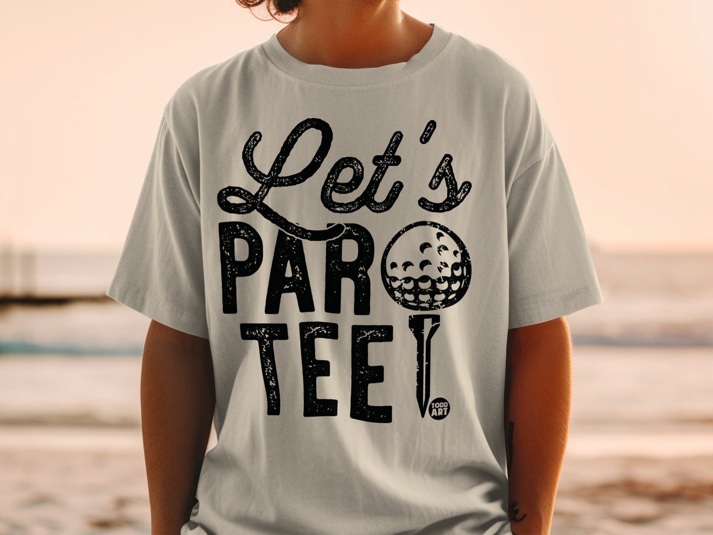 Light gray t-shirt with black "Let's Par Tee!" text and a golf ball.