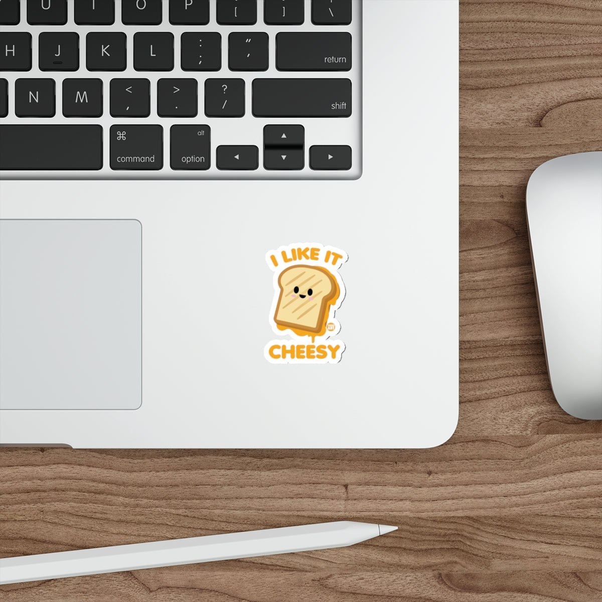Cheesy toast sticker saying "I like it cheesy" on a laptop.
