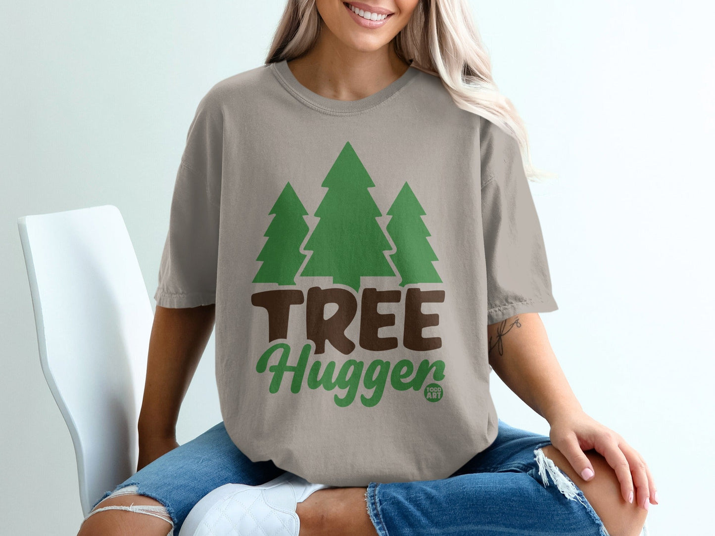 Tan t-shirt with green trees and "TREE Hugger" text.