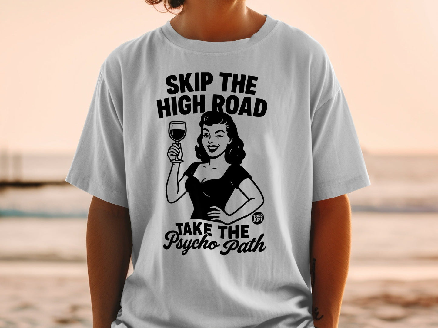 Woman in vintage style holding wine glass, text "SKIP THE HIGH ROAD TAKE THE PSYCHO PATH".