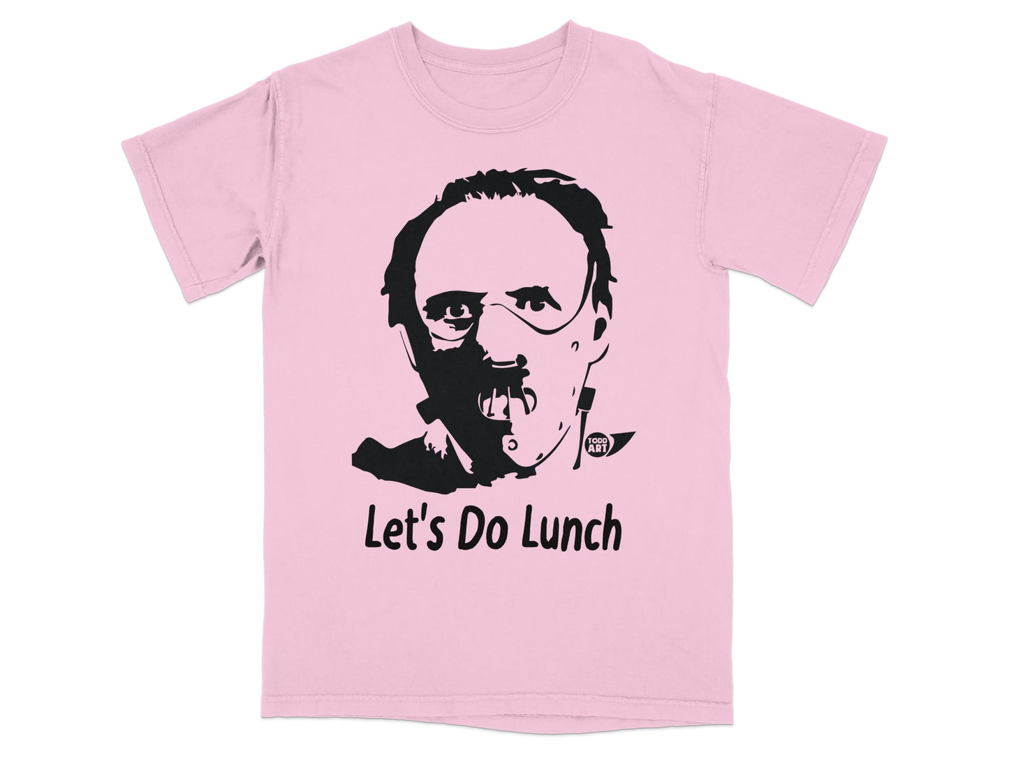 Pink t-shirt with a black graphic of Hannibal Lecter's face and "Let's Do Lunch" text.