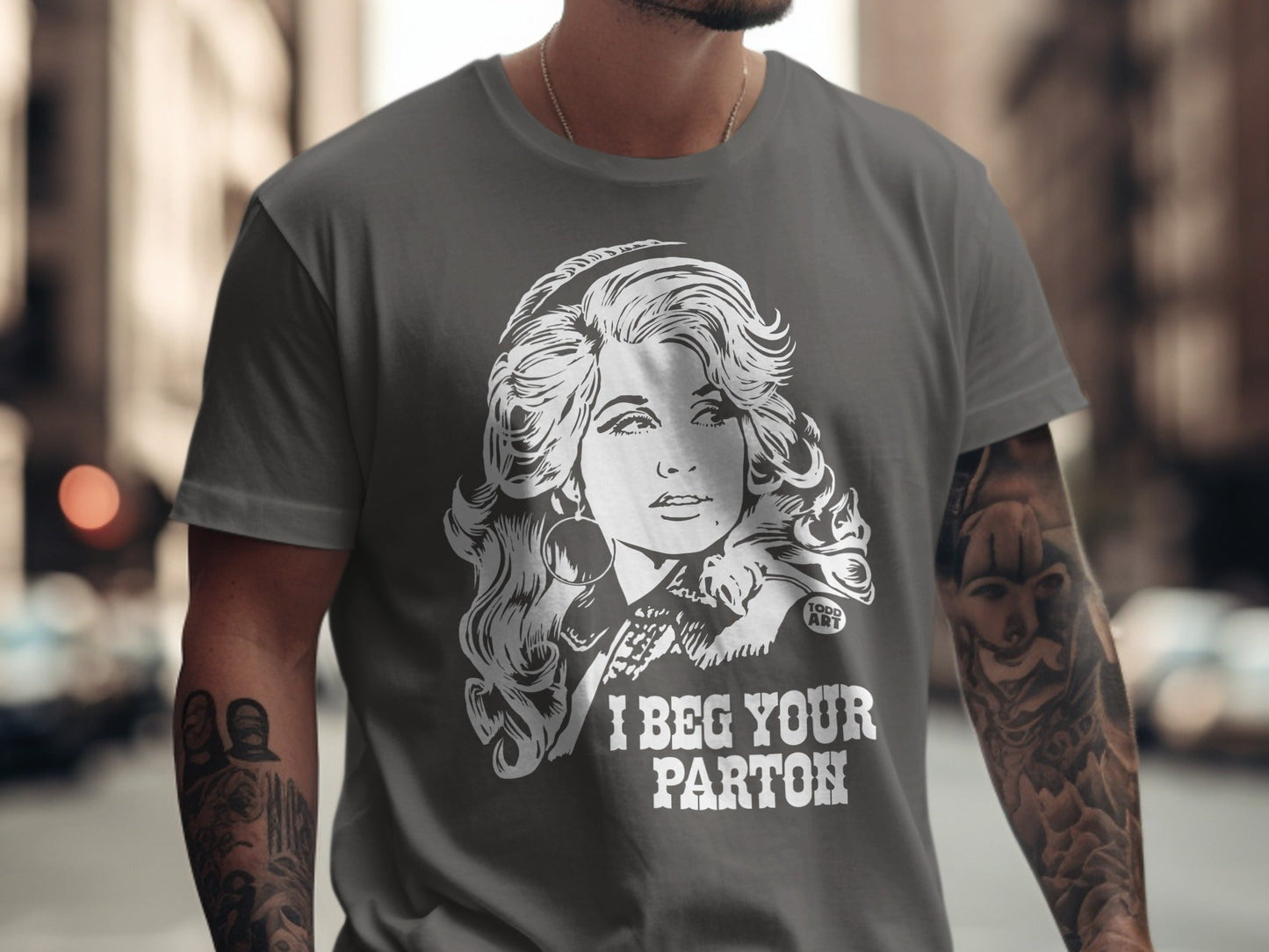 T-shirt with Dolly Parton graphic and text "I BEG YOUR PARTON".