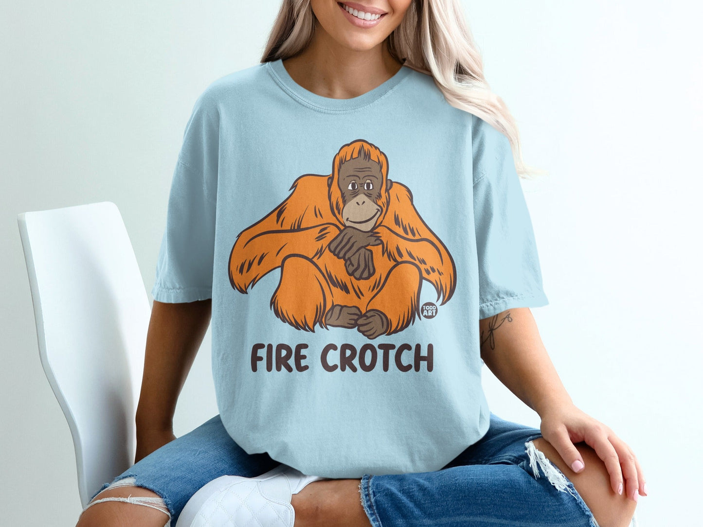 Light blue t-shirt with cartoon orangutan and "FIRE CROTCH" text.