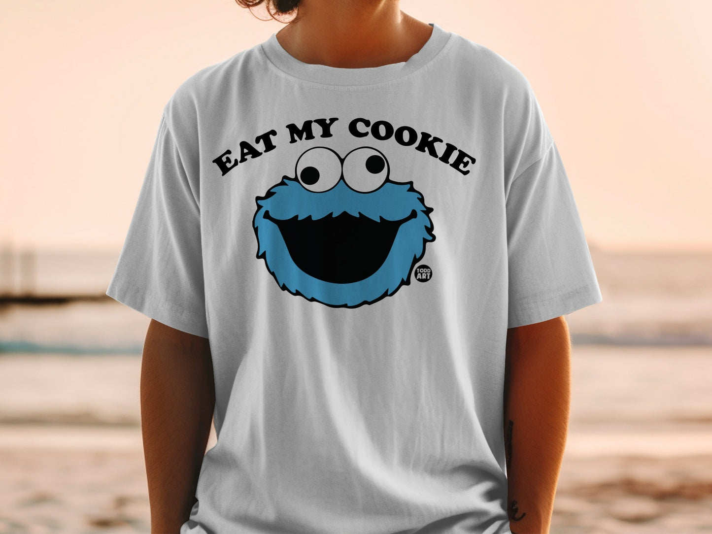 White t-shirt with Cookie Monster graphic and "EAT MY COOKIE" text.