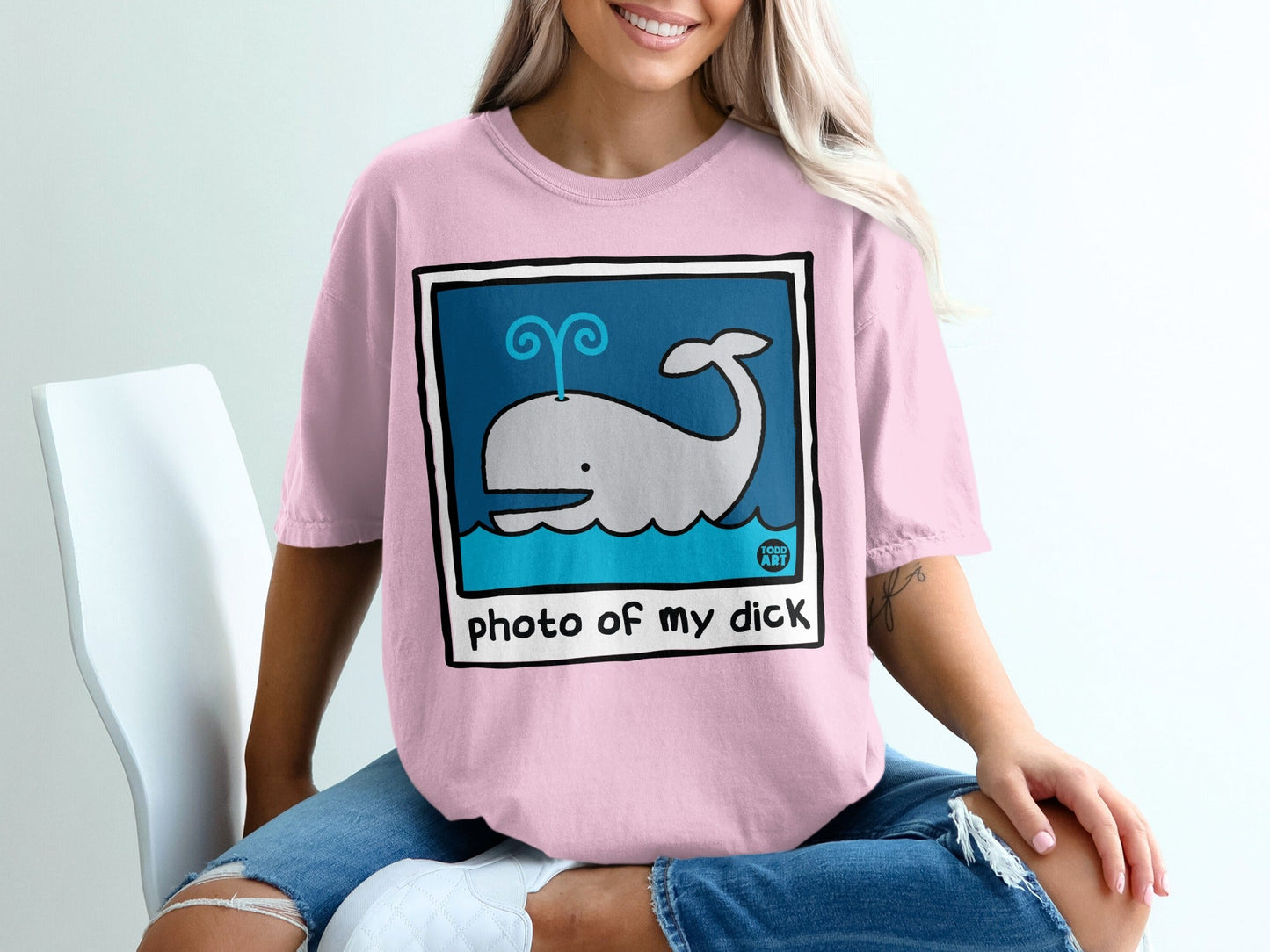 Pink t-shirt with cartoon whale and "photo of my dick" text.