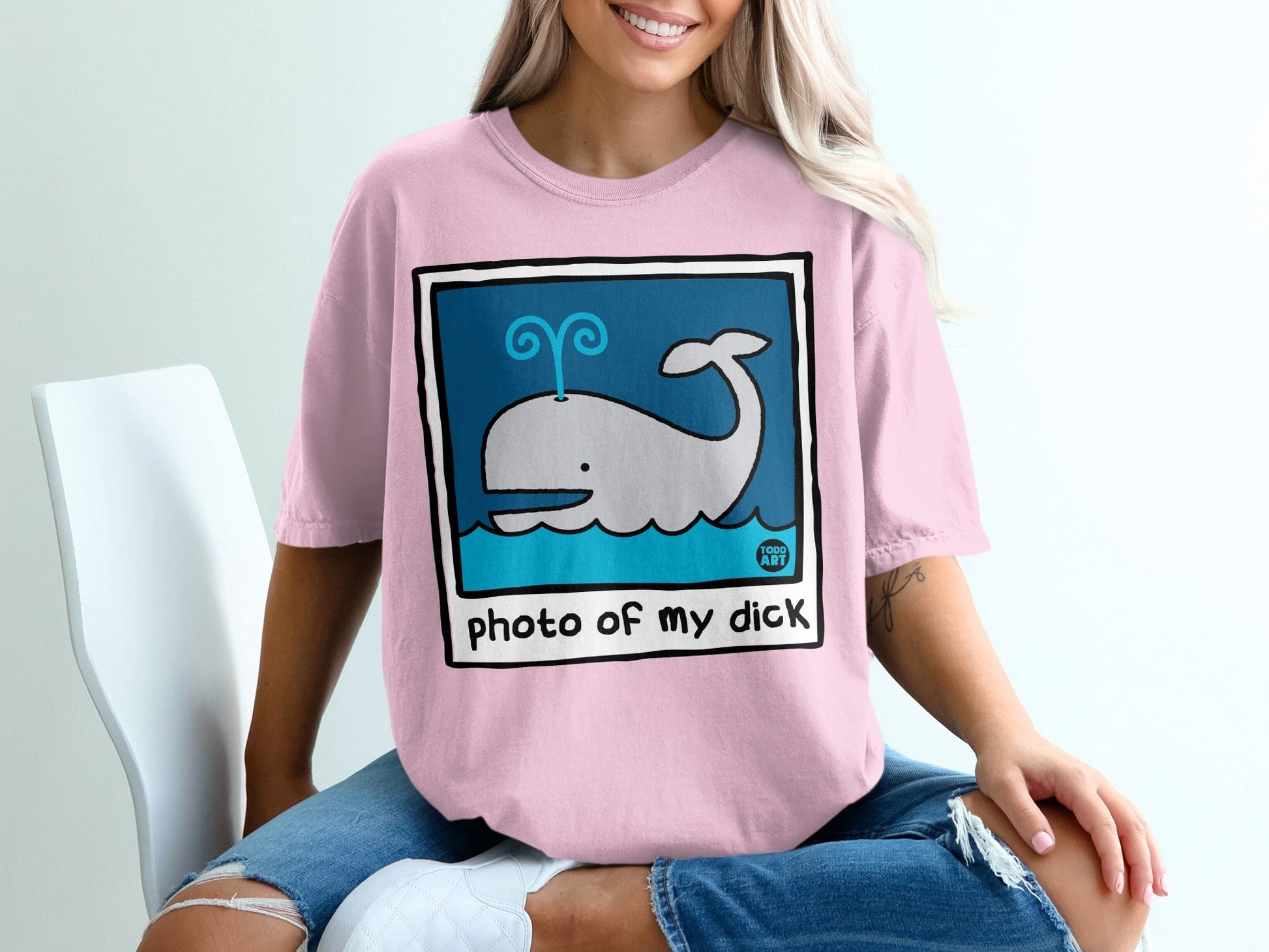 Pink t-shirt with cartoon whale and "photo of my dick" text.