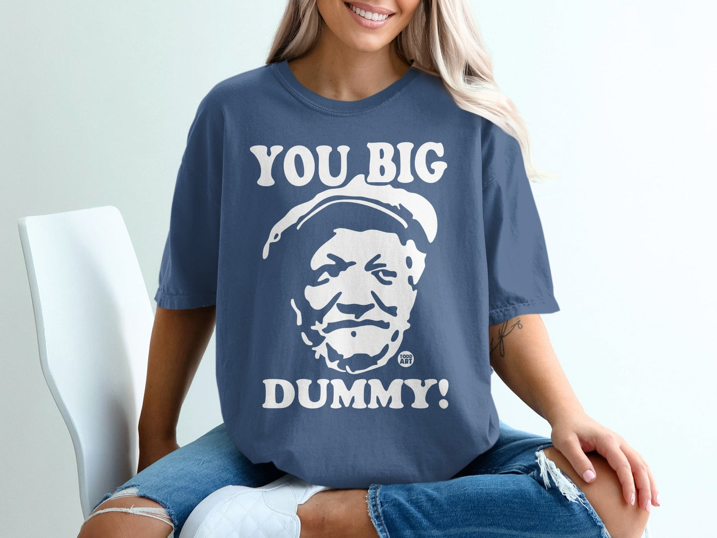 Blue t-shirt with white text "YOU BIG DUMMY!" and a black and white portrait.