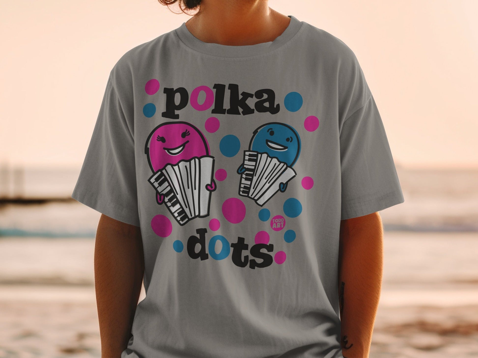 T-shirt featuring two cartoon accordions with faces, saying "Polka Dots".