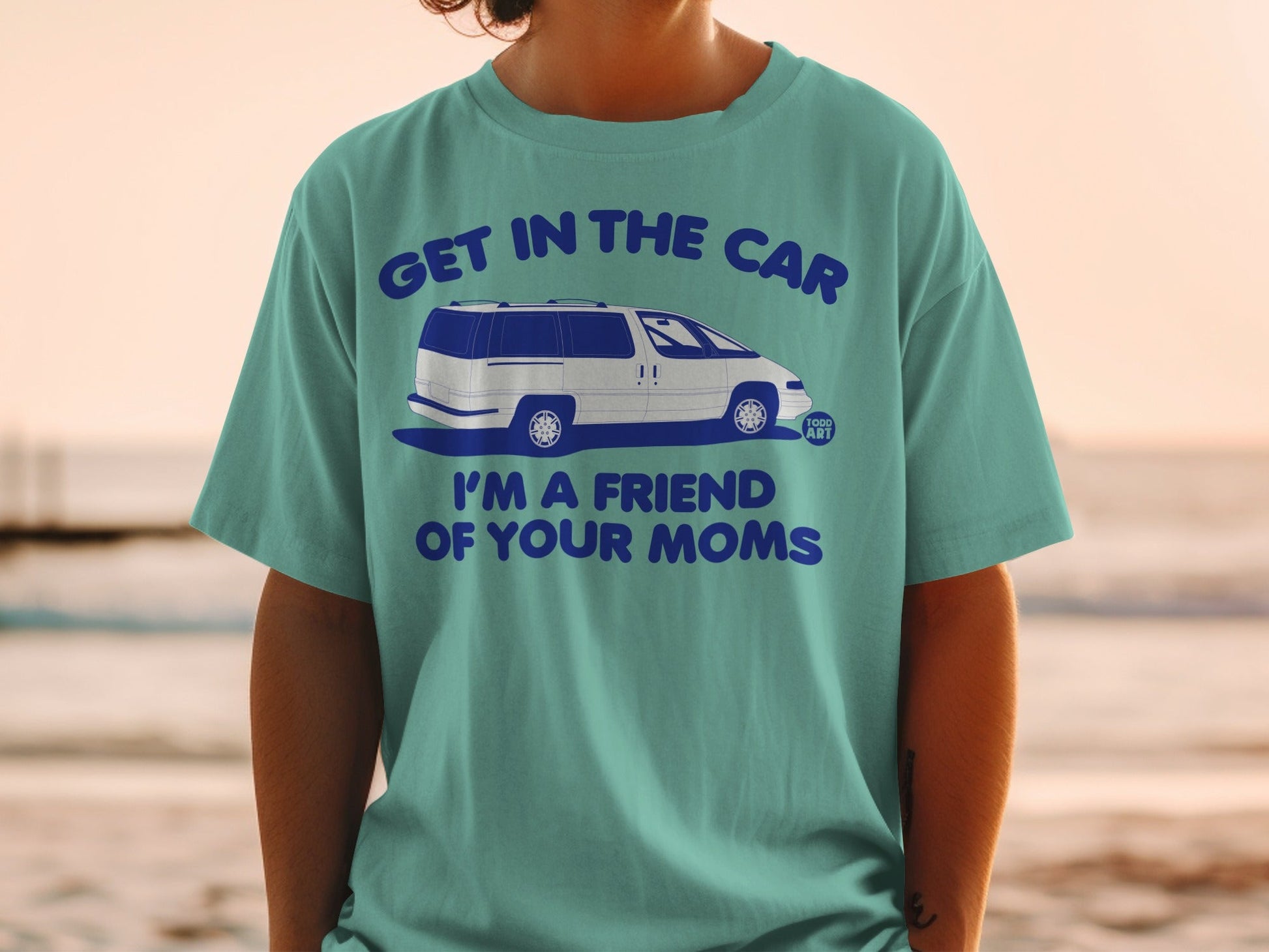 Teal t-shirt with white van and text "GET IN THE CAR I'M A FRIEND OF YOUR MOMS".