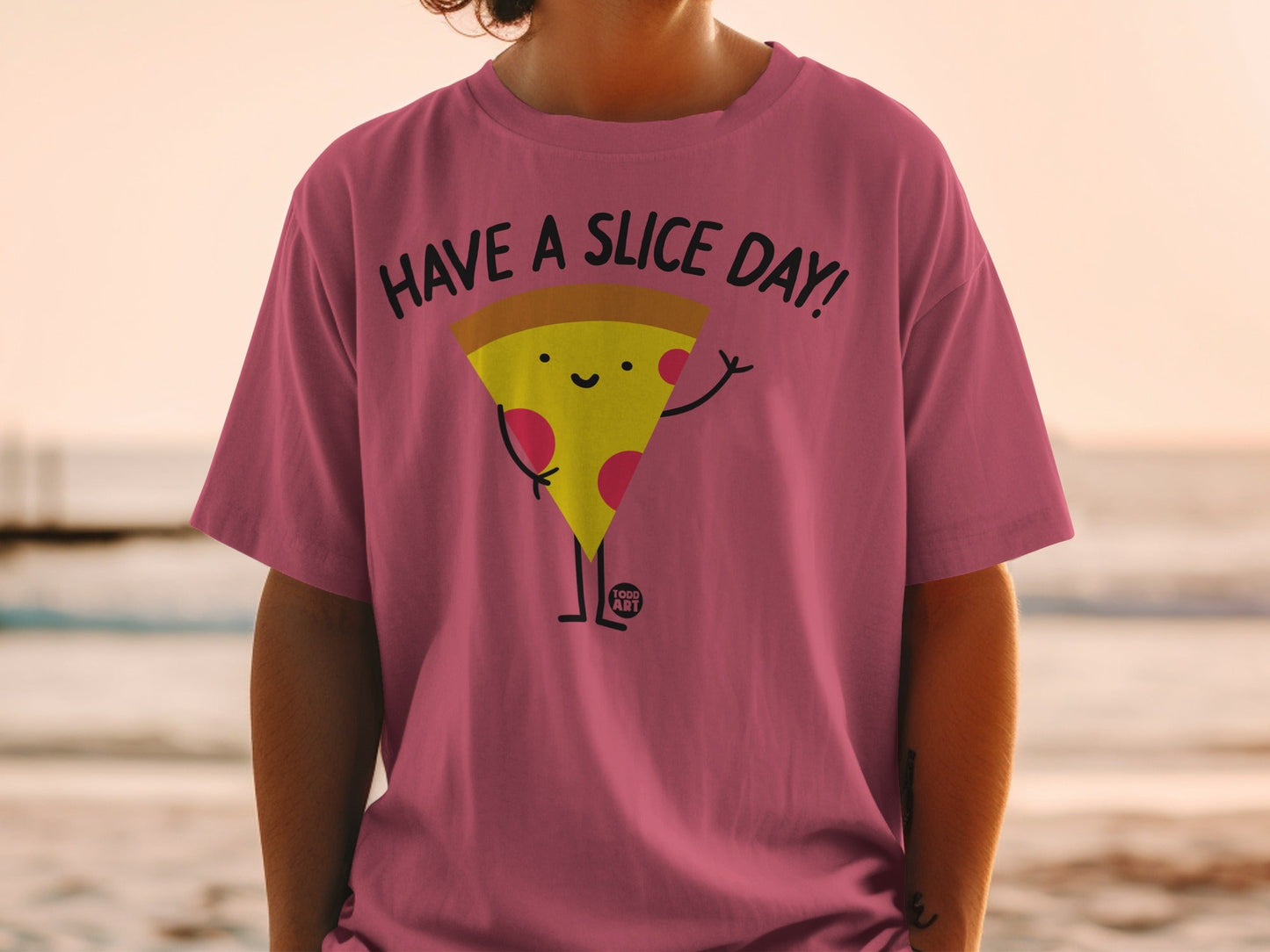 Pink t-shirt with a cartoon pizza slice saying "Have a Slice Day!"