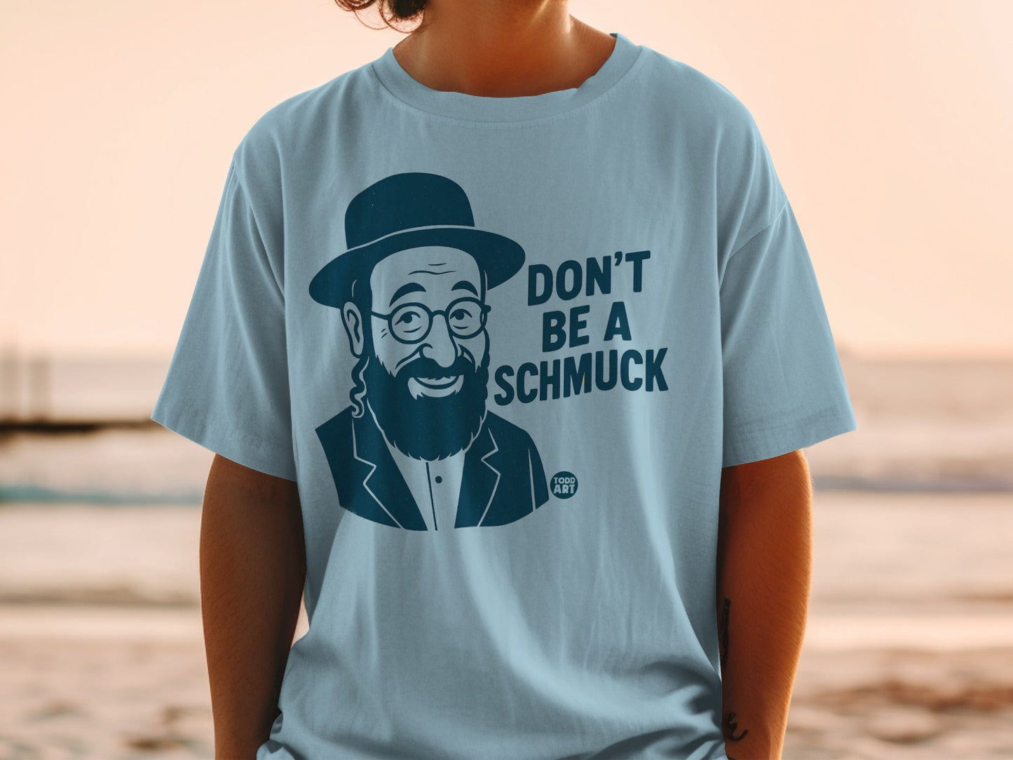 Light blue t-shirt with "DON'T BE A SCHMUCK" and a caricature of a man.